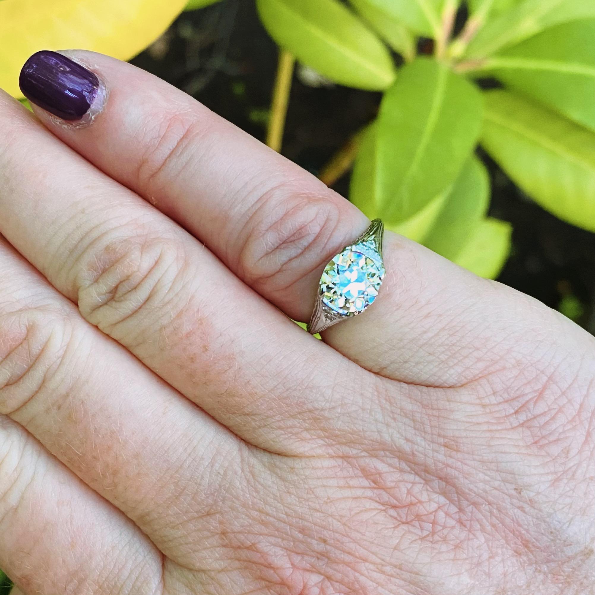 A piece of history in exceptional condition. This platinum stunner circa 1890-1920 features a phenomenal 1.60 carat Old European Cut Diamond set in a beautifully engraved ring featuring immaculate filigree work and six fine accent diamonds for