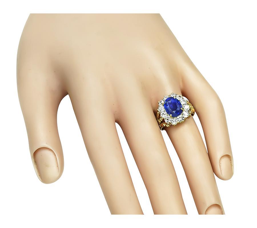 This is a stunning 14k yellow gold ring from the Victorian era. The ring is centered with lovely oval cut sapphire that weighs approximately 2.69ct. The sapphire is accentuated by sparkling old mine cut diamonds that weigh approximately 1.40ct. The