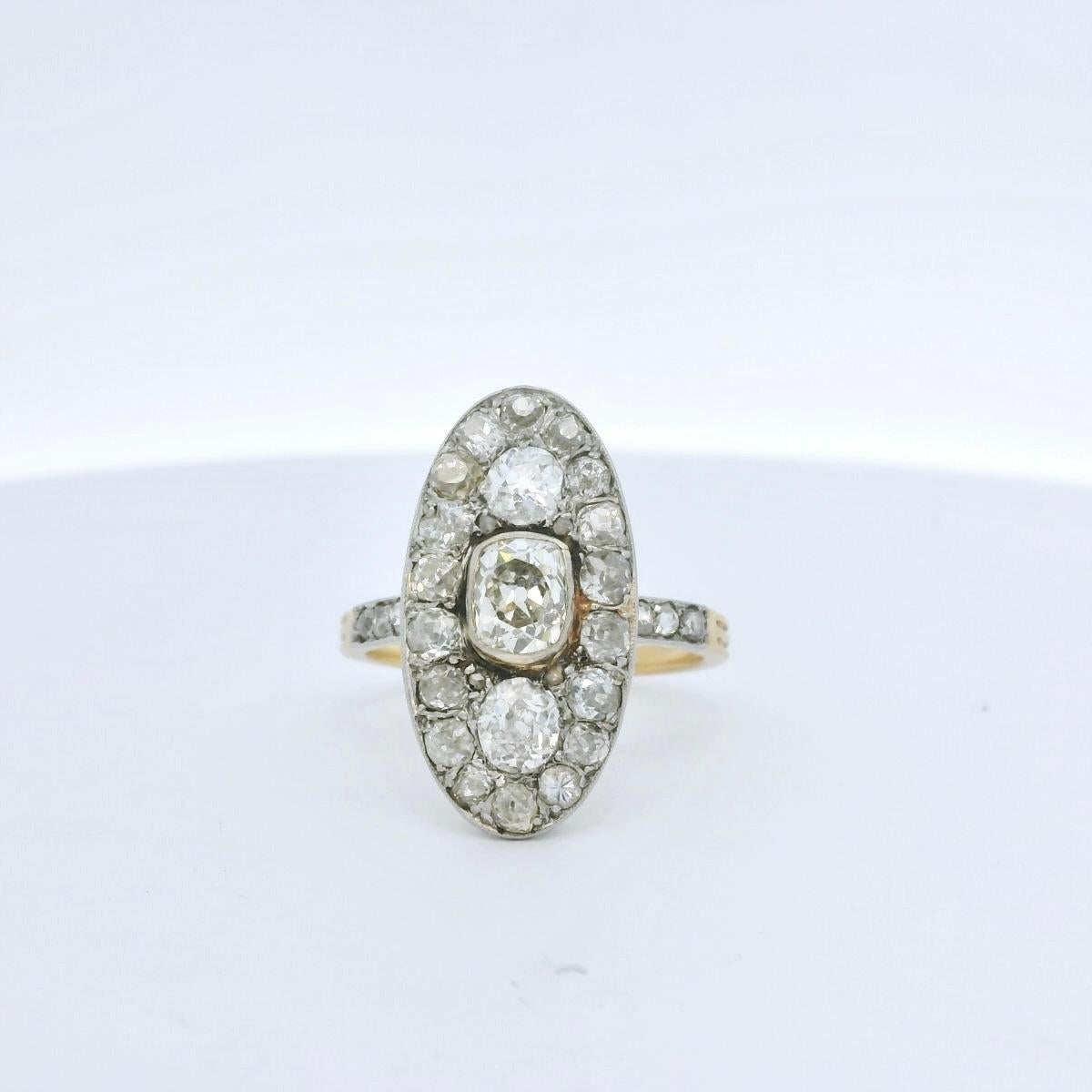 Antique Diamond ring circa 1900. 

The ring is set with a very nice center old mine diamond of approximately 1 Carat ( Estimated J/K color - Vs clarity), two bigger old mine diamonds surrounded by 18 old European diamonds for a total of