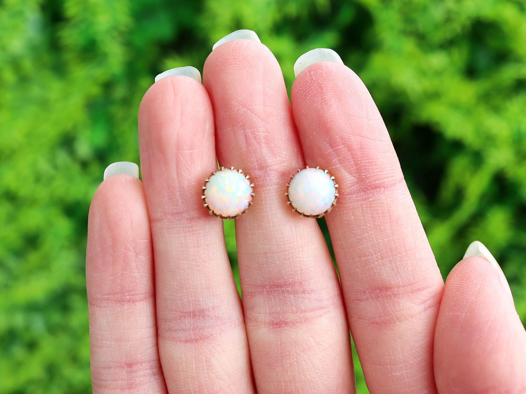 A fine and impressive pair of antique 2.80 carat opal and 9 karat yellow gold stud earrings; part of our diverse opal jewellery collection.

These fine and impressive antique earrings have been crafted in 9k yellow gold.

Each circular earring