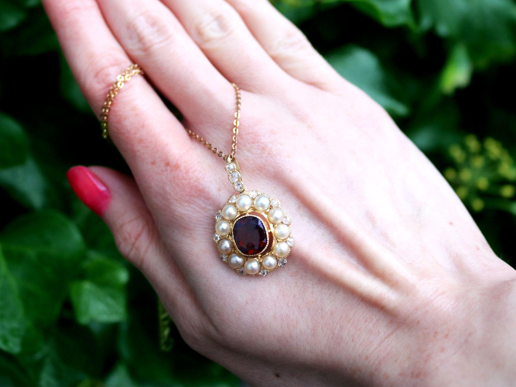 A stunning, fine and impressive 2.96 carat garnet, pearl and 0.72 carat diamond, 12k yellow gold pendant - boxed; an addition to our antique jewellery and estate jewelry collections.

This impressive antique pendant has been crafted in 12k yellow