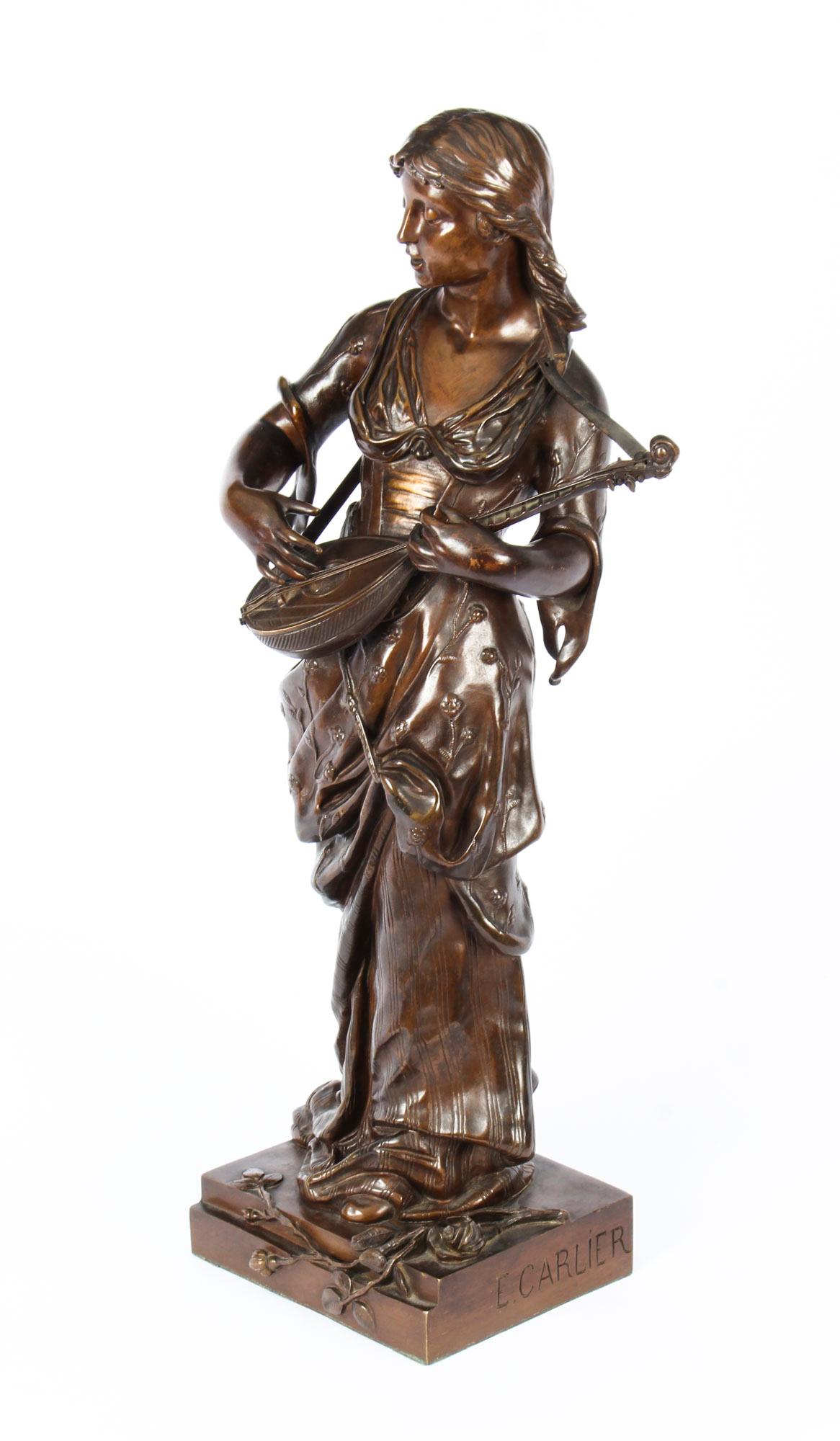 This is a gorgeous large French bronze sculpture of a maiden playing a lute, by Albert Ernst Carrier - Belleuse, circa 1860 in date.
 
The sculpture features a graceful maiden dressed in a classical flowing costume decorated with foliate and floral