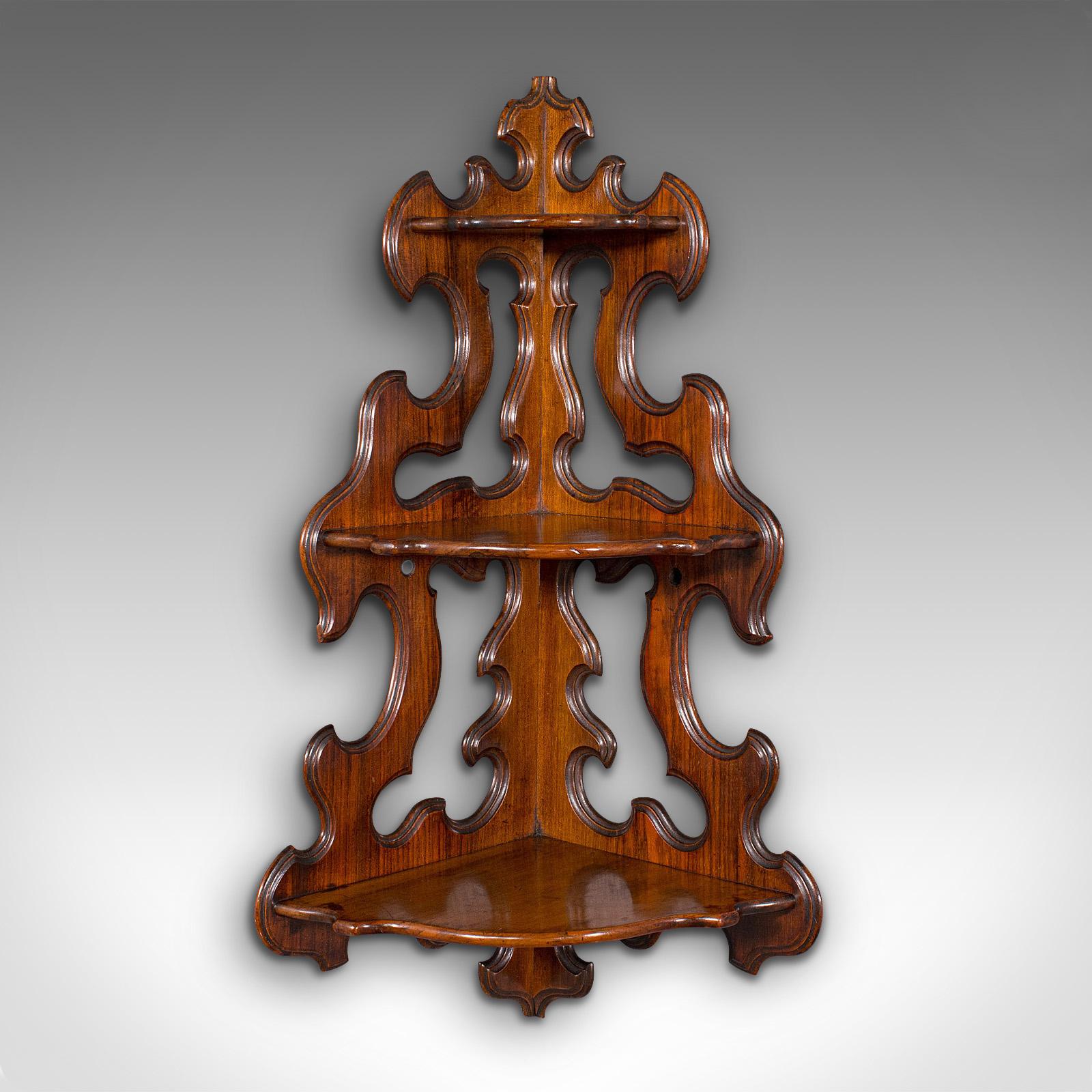 This is an antique three-tier hanging whatnot. An English, rosewood corner wall shelf or candle bracket, dating to the early Victorian period, circa 1850.

Distinctive wall mounted corner whatnot with striking form
Displays a desirable aged