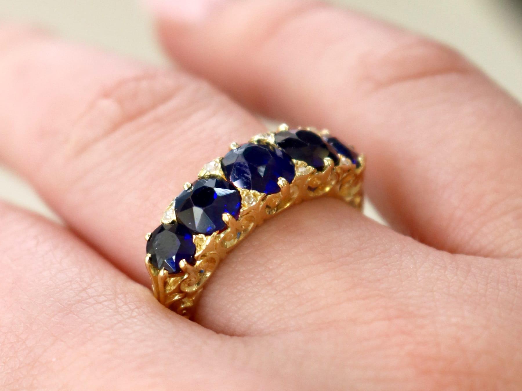 Oval Cut Antique 3.15 Carat Basaltic Sapphire and Diamond Five Stone Ring in Yellow Gold For Sale