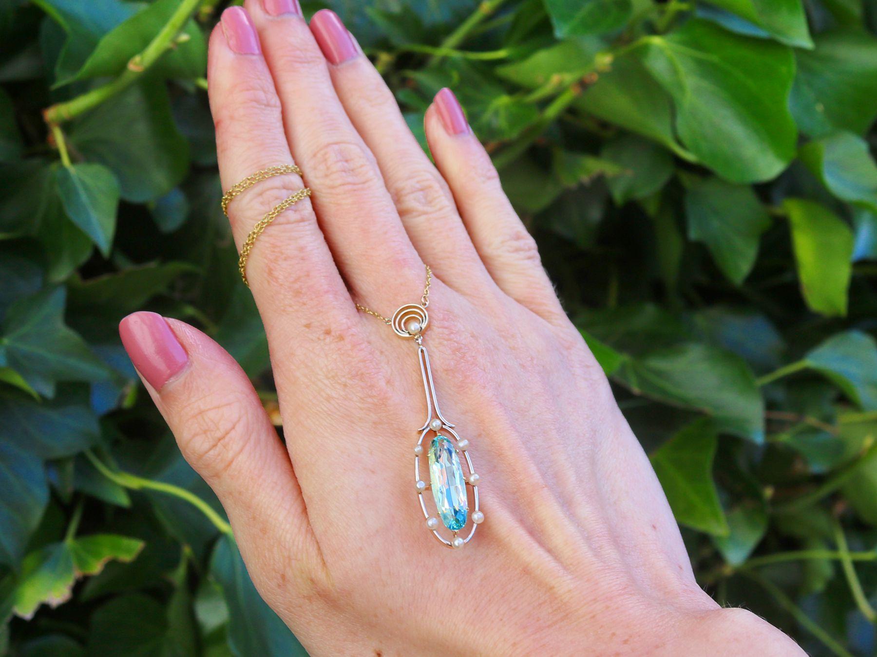 A fine and impressive 3.20 carat aquamarine, pearl, 14 karat yellow gold and platinum pendant; part of our antique jewelry and estate jewelry collections.

This fine and impressive aquamarine pendant has been crafted in 14k yellow gold with a