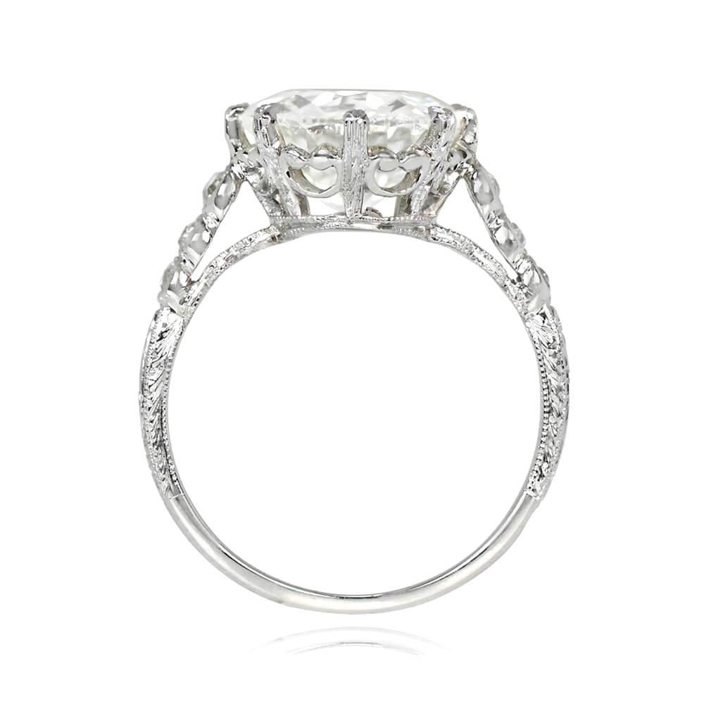 This is a stunning antique Art Deco diamond solitaire engagement ring with a 3.62 carat old European cut diamond, L color and SI1 clarity, set in prongs. The shoulders feature bezel-set single-cut diamonds, while the shank is adorned with intricate