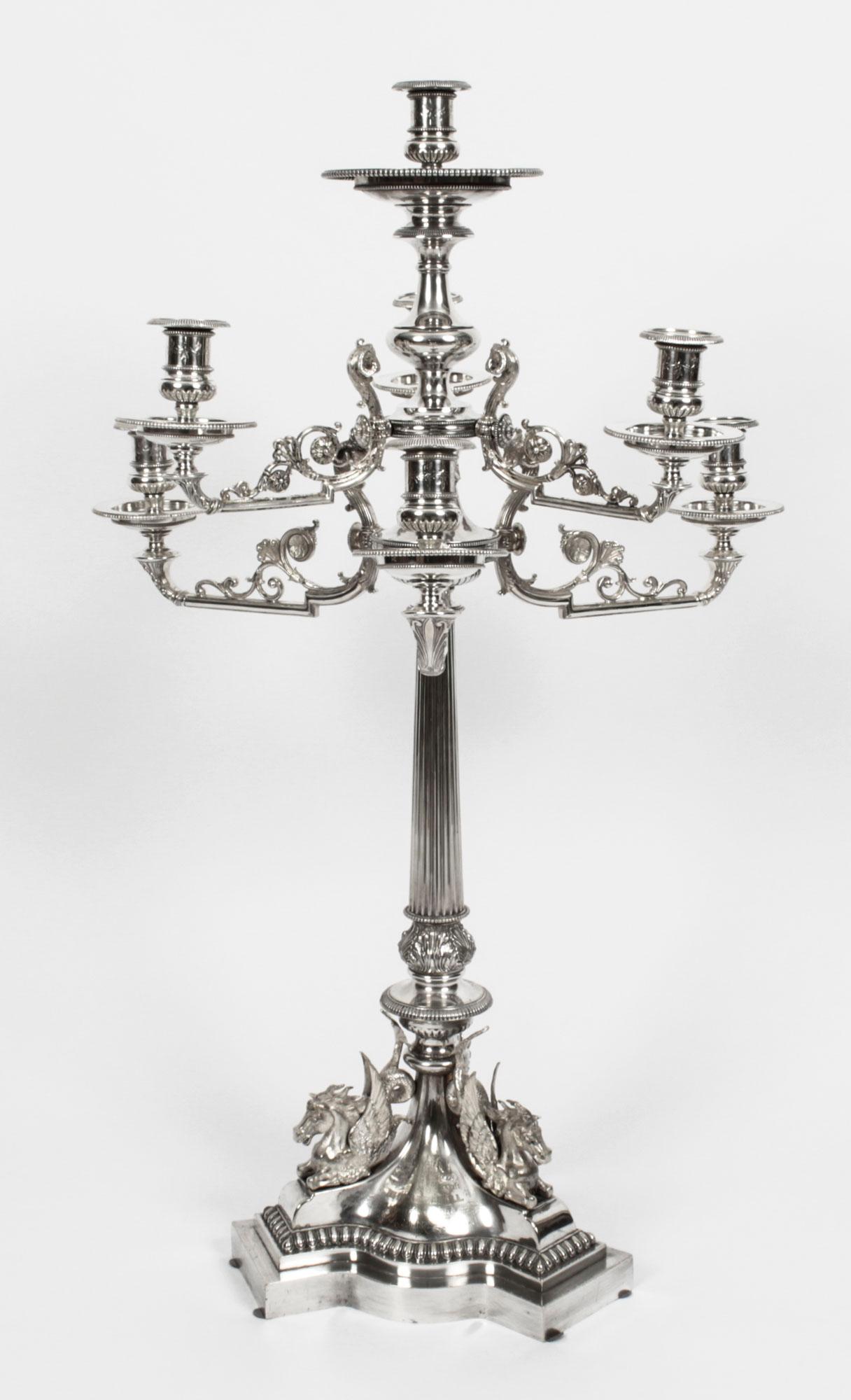 This is a magnificent and rare monumental antique English Victorian silver plated bronze figural candelabra centrepiece by the renowned silversmiths Elkington, Circa 1860 in date.

It is a superb quality monumental seven light cast candelabra with