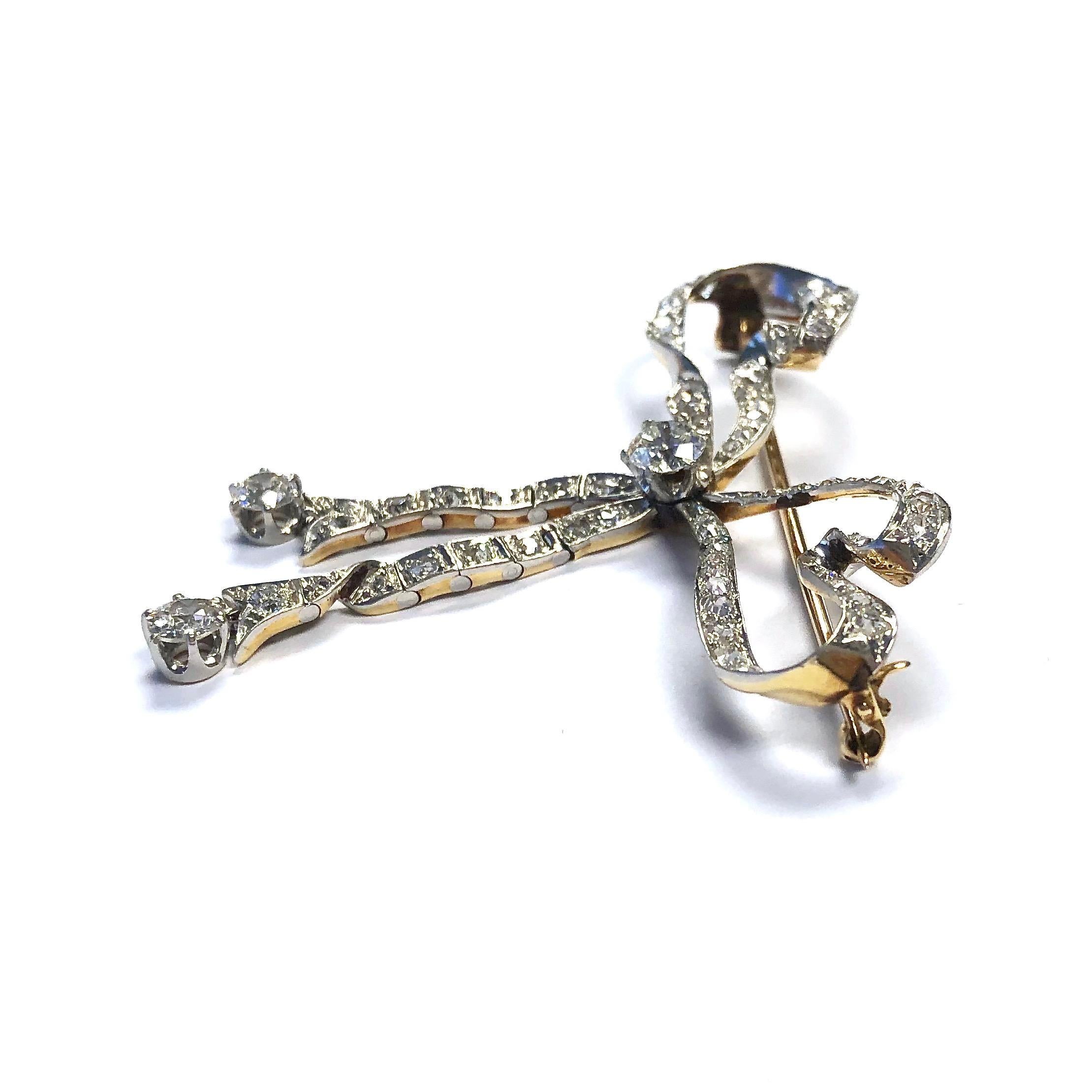 Victorian era large bow pin with four carats of diamonds set in platinum topped 18K yellow gold. 
Diamonds: 4ctw VS-SI/G-H
Measurements: 2 1/8