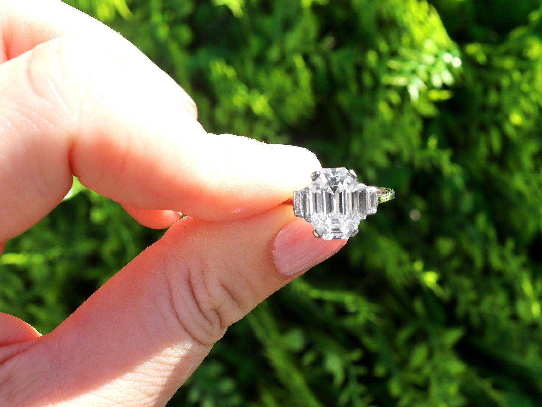 A magnificent, stunning, fine and impressive antique 4.02 carat emerald cut diamond solitaire ring in platinum; part of our antique engagement ring collections.

This stunning, fine and impressive antique diamond ring has been crafted in