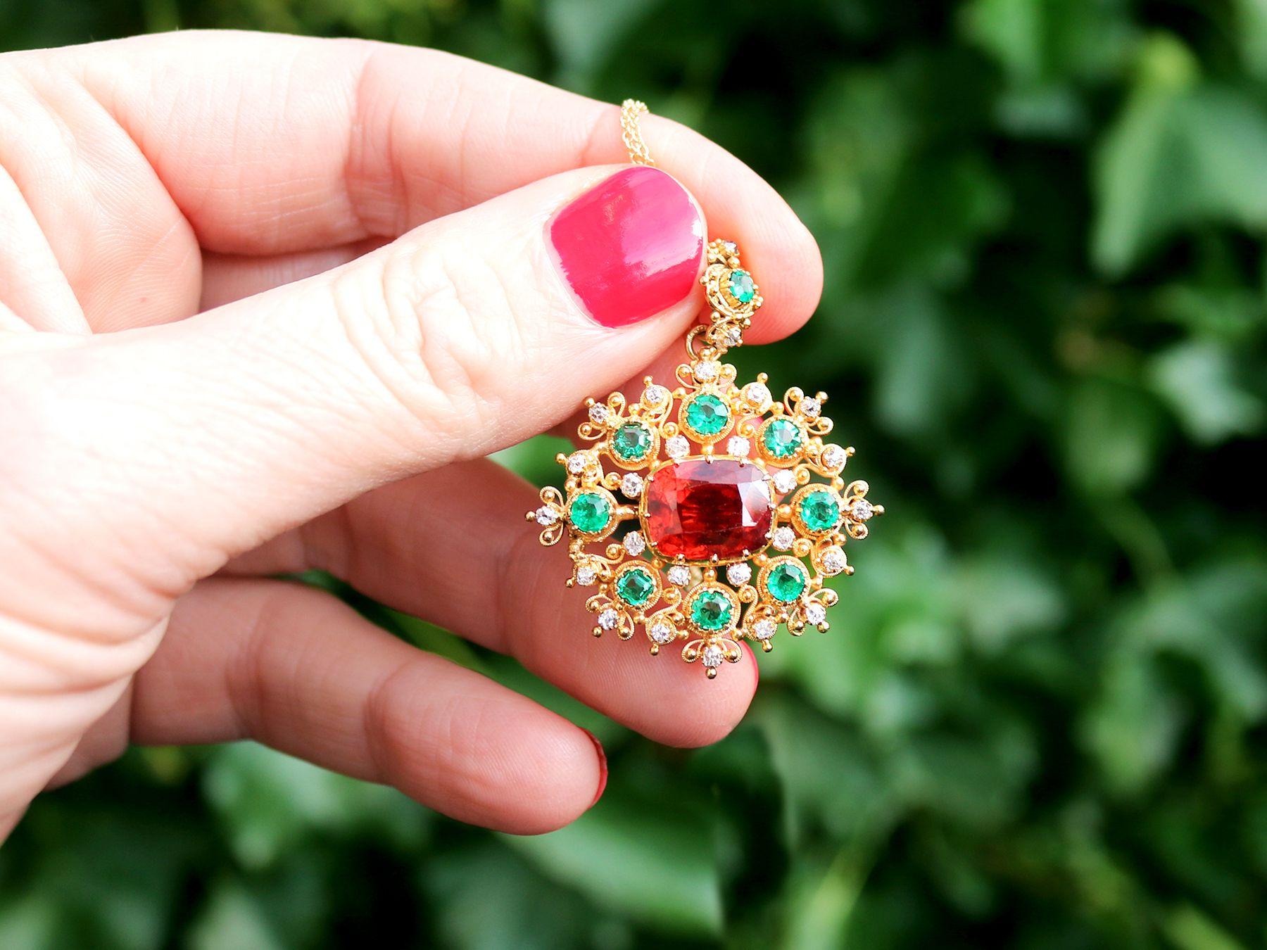A stunning, fine and impressive Victorian 4.10 carat garnet, 1.36 carat emerald and 0.48 carat diamond, 18 karat yellow gold pendant/brooch; part of our diverse antique jewellery collections.

This stunning, fine and impressive antique pendant has