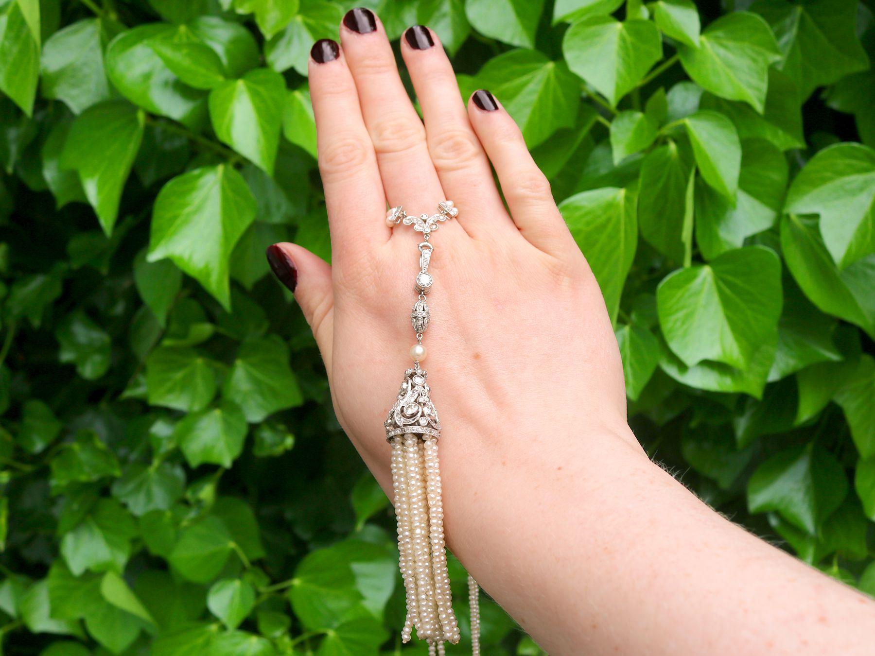 A stunning antique 1920s 4.41 carat diamond and seed pearl, platinum sautoir necklace; part of our diverse antique jewelry and estate jewelry collections

This stunning, fine and impressive antique pearl sautoir necklace has been crafted in