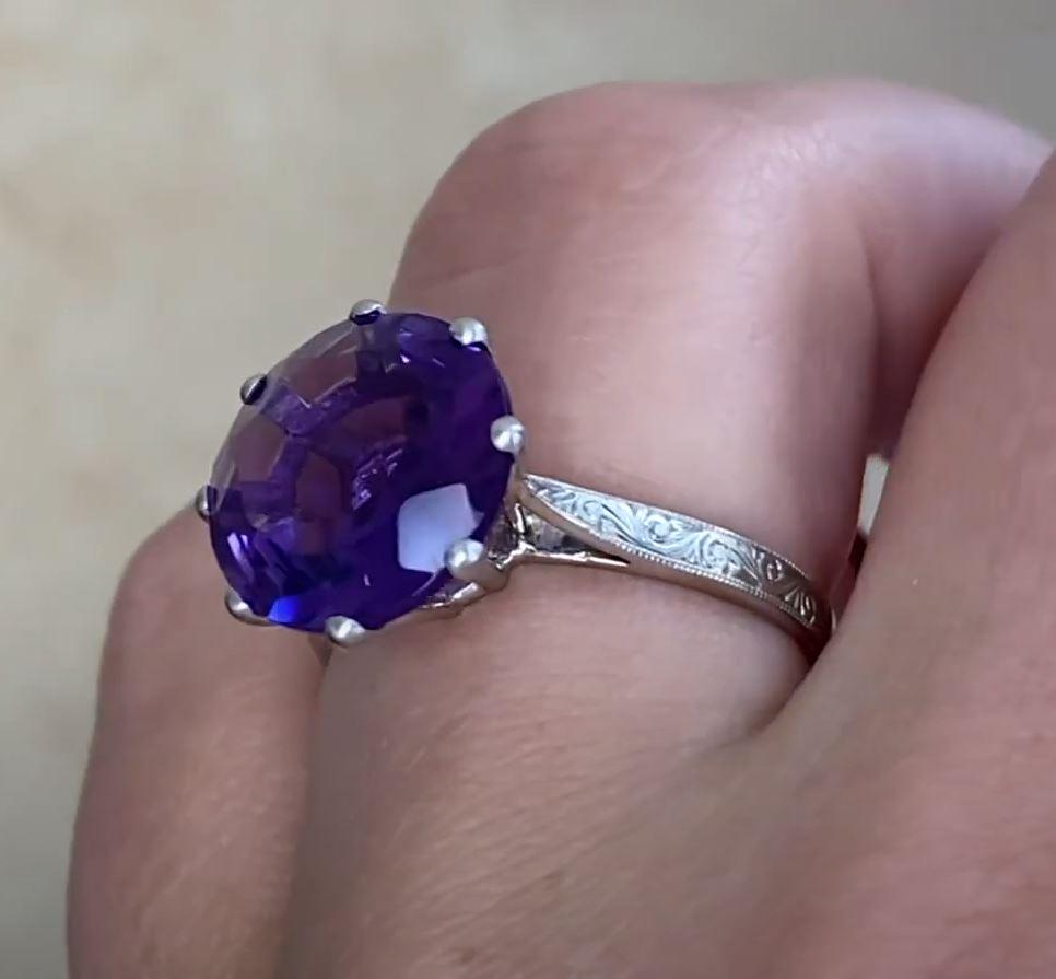 This exquisite antique ring showcases a captivating approx. 4.50-carat round-cut amethyst, radiating a deep, regal hue. Set securely within an elegant eight-prong setting, the center stone commands attention with its brilliance and remarkable