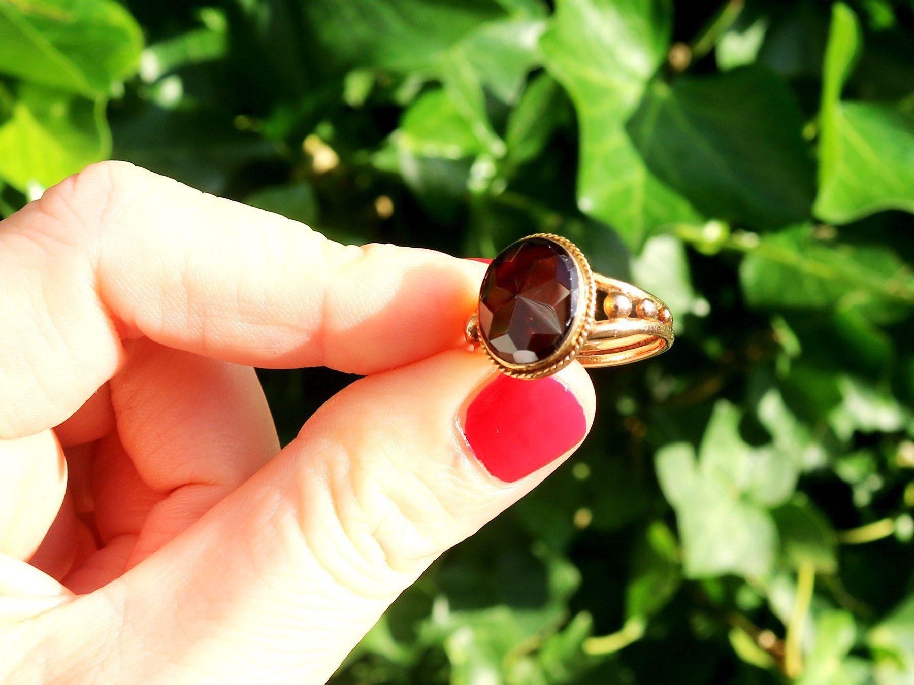 A fine and impressive 4.75 carat garnet and 15 karat yellow gold dress ring; part of our diverse antique jewelry and estate jewelry collections.

This impressive Victorian ring has been crafted in 15k yellow gold.

The substantial antique ring