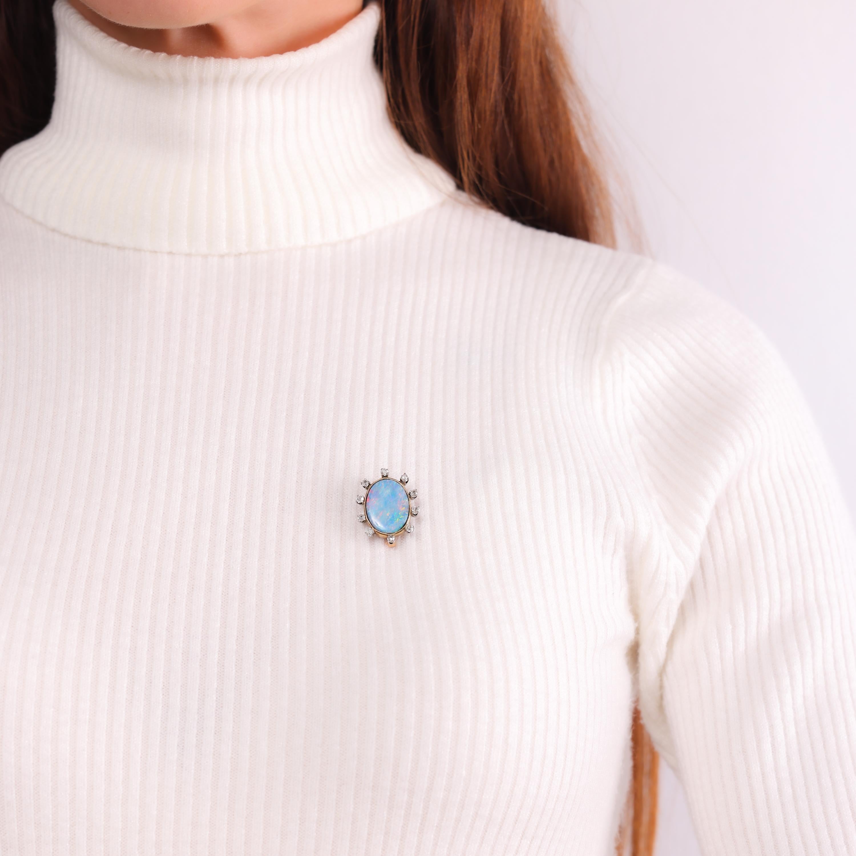 This antique brooch features a luminous 4.90-carat doublet opal framed by sparkling old mine-cut diamonds, elegantly set in 18k yellow gold and platinum. A timeless treasure from the 1890s.

Center stone: Oval cut doublet opal 
Weight: Approximately