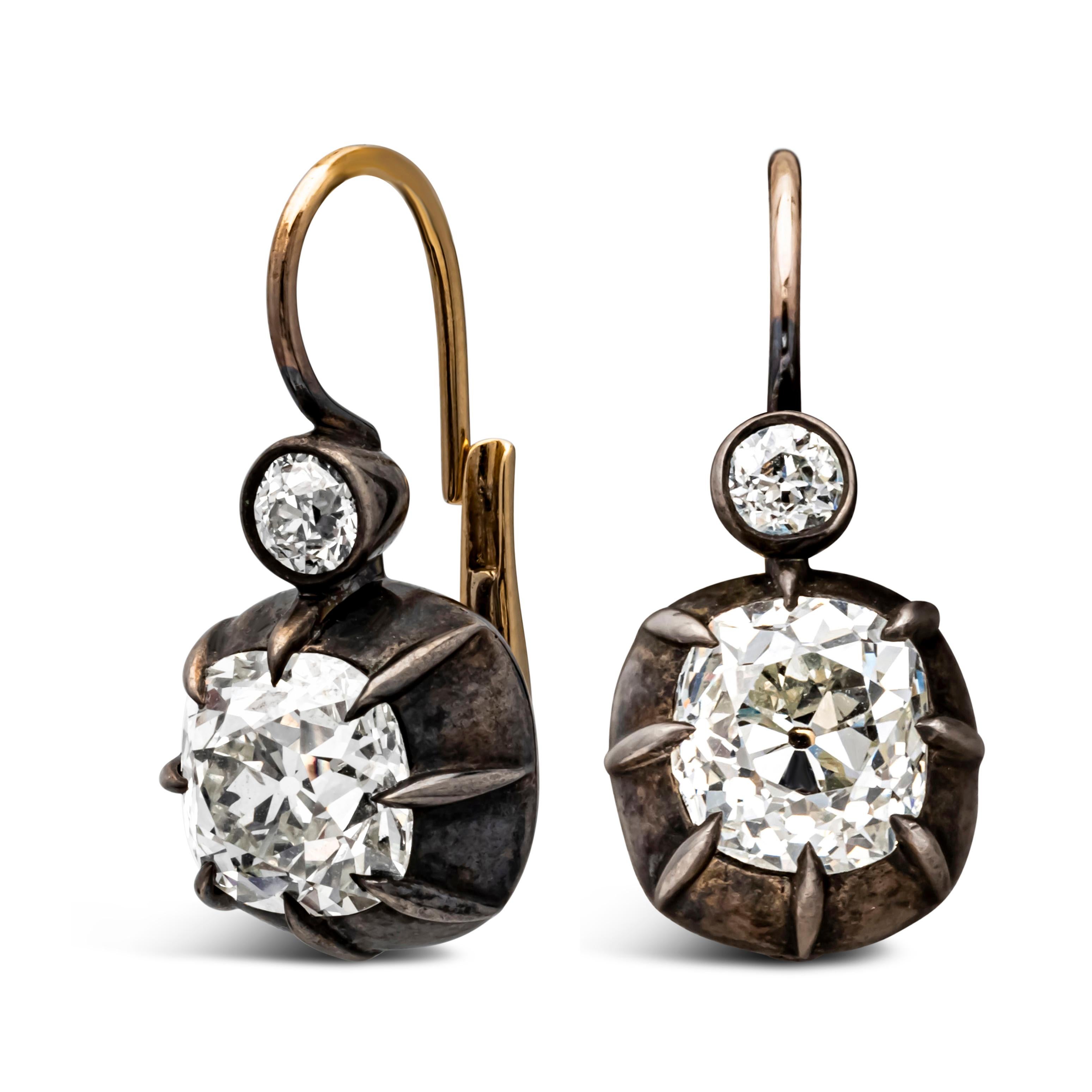 Features two old mine cushion cut diamonds of 2.34 carats and 2.63 carats. The diamonds are I-J color approximately and VS-SI in clarity. The diamonds accented on the top by 2 small Old European diamonds, weighing 0.36 carat total. The earrings made