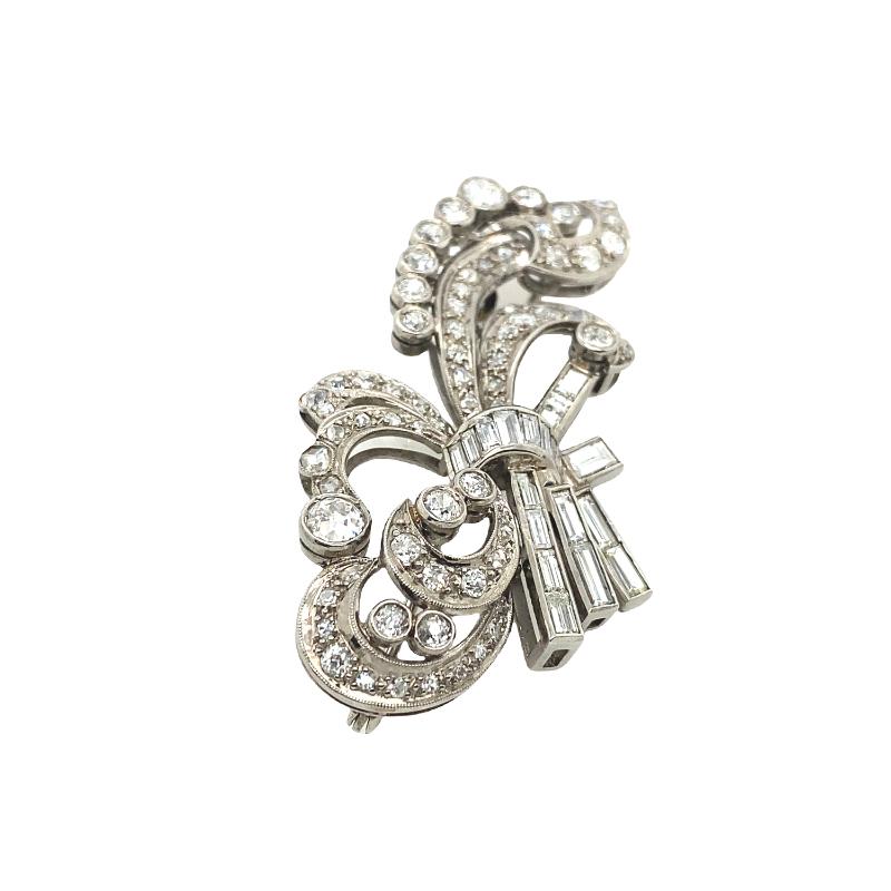 This beautiful brooch features a 4ct Diamond flower set with baguettes, princess cut and round Victorian diamonds. (Not hallmarked but laser tested as palladium)

Additional Information:
Total Diamond Weight: 4.0ct
Diamond Colour: I
Diamond Clarity:
