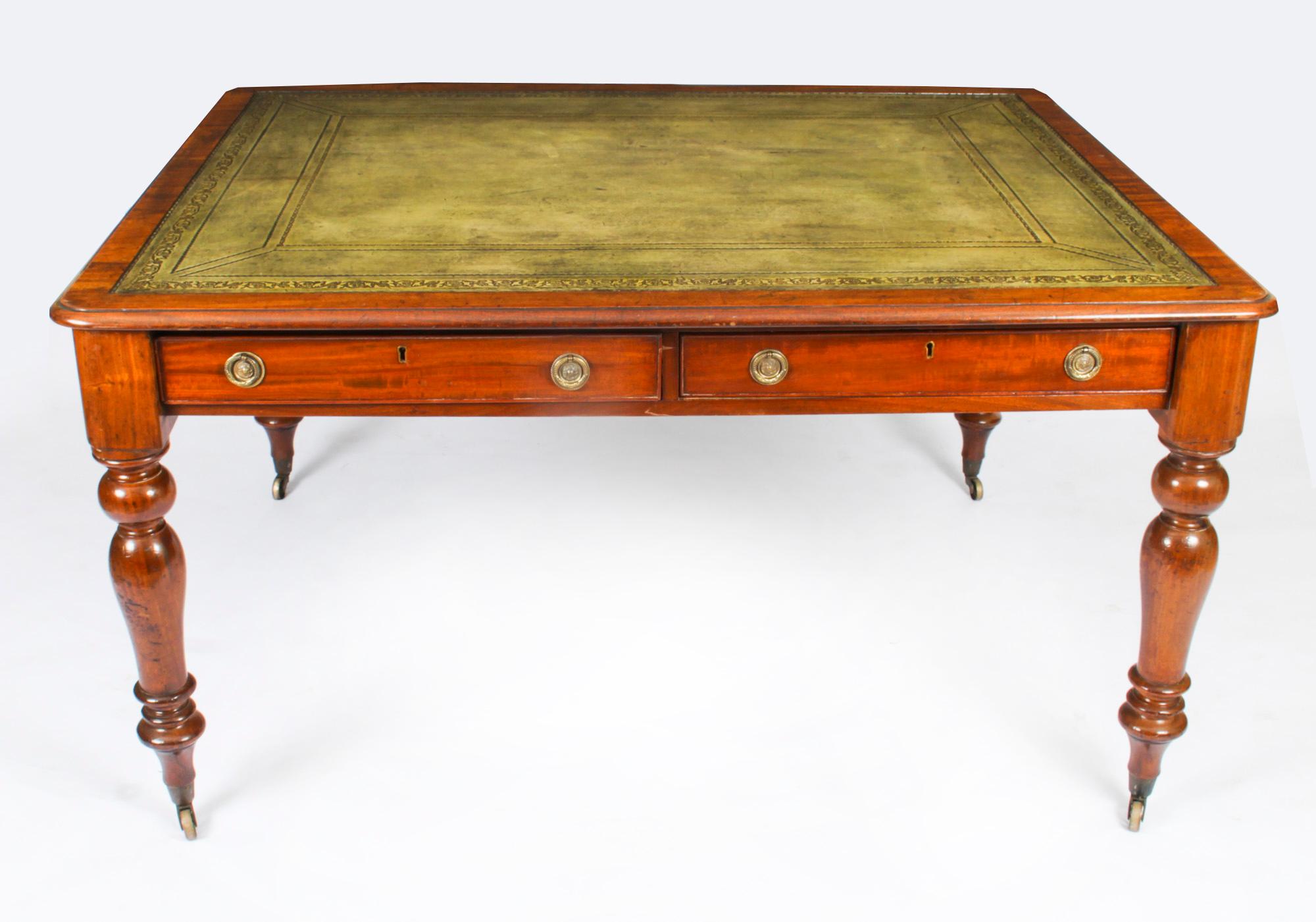 This is a superb antique Victorian partners writing table, crafted from beautiful flame mahogany and dating from Circa 1860.
 
The rectangular top features a moulded edge with an inset faded green and gilt tooled leather writing surface over four