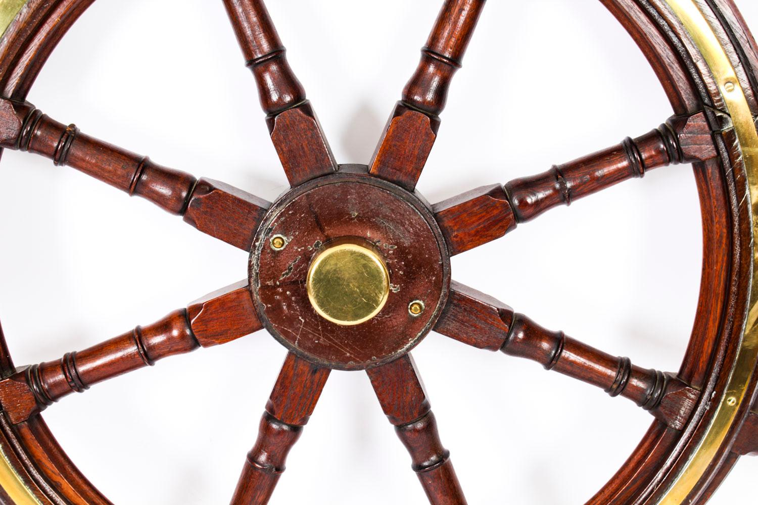 This is an elegant and large antique Victorian teak and brass set ships wheel, circa 1880 in date.

This splendid nautical collectable features eight stylish turn king cylindrical spokes ending in handles, and is made from beautiful high-quality
