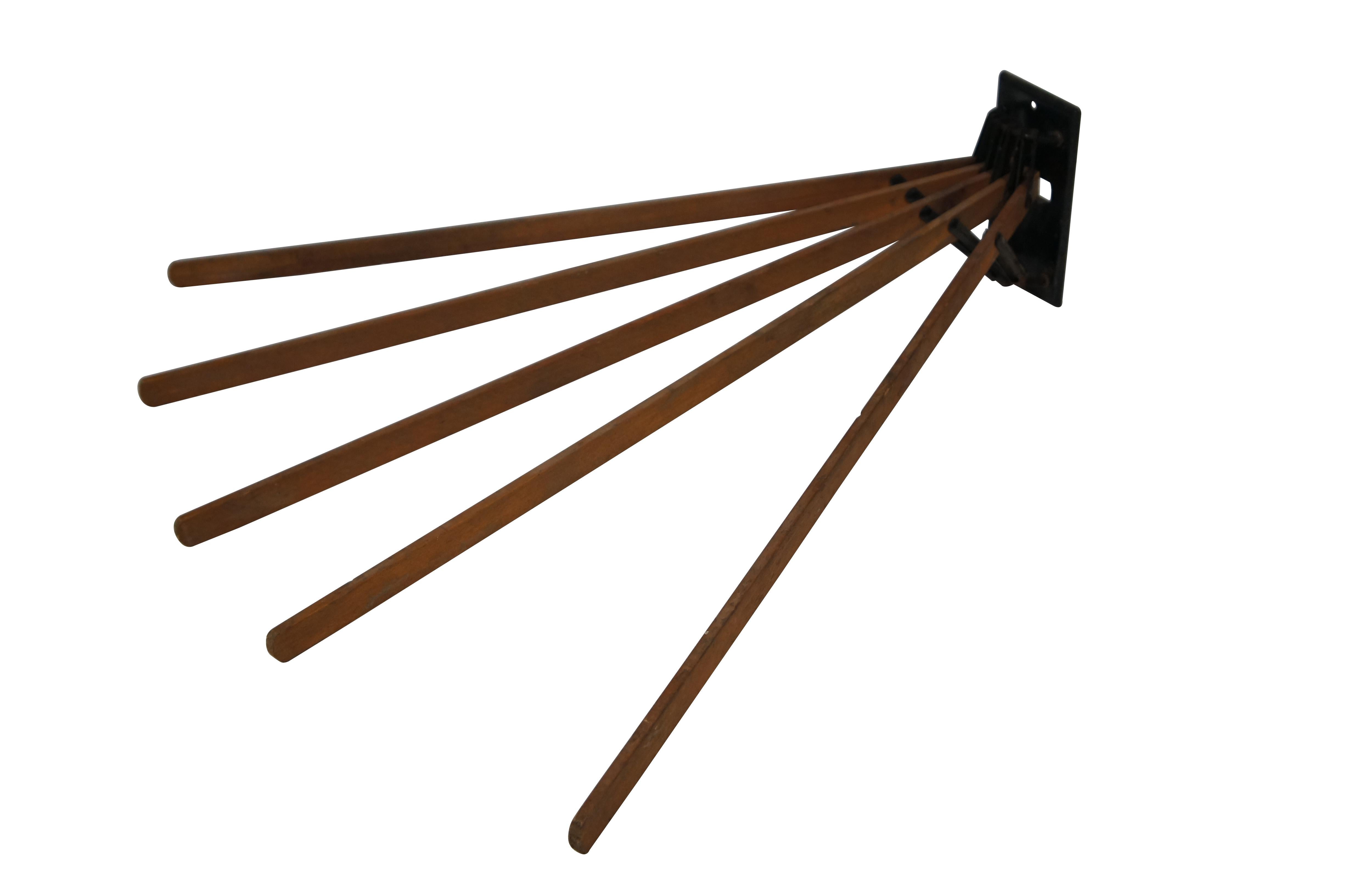 Antique wall mounted drying rack featuring black metal hardware and five wooden arms that extend out in a fan shape or can be folded neatly against the wall via spring action mechanism.

Dimensions:
Measured Open - 24