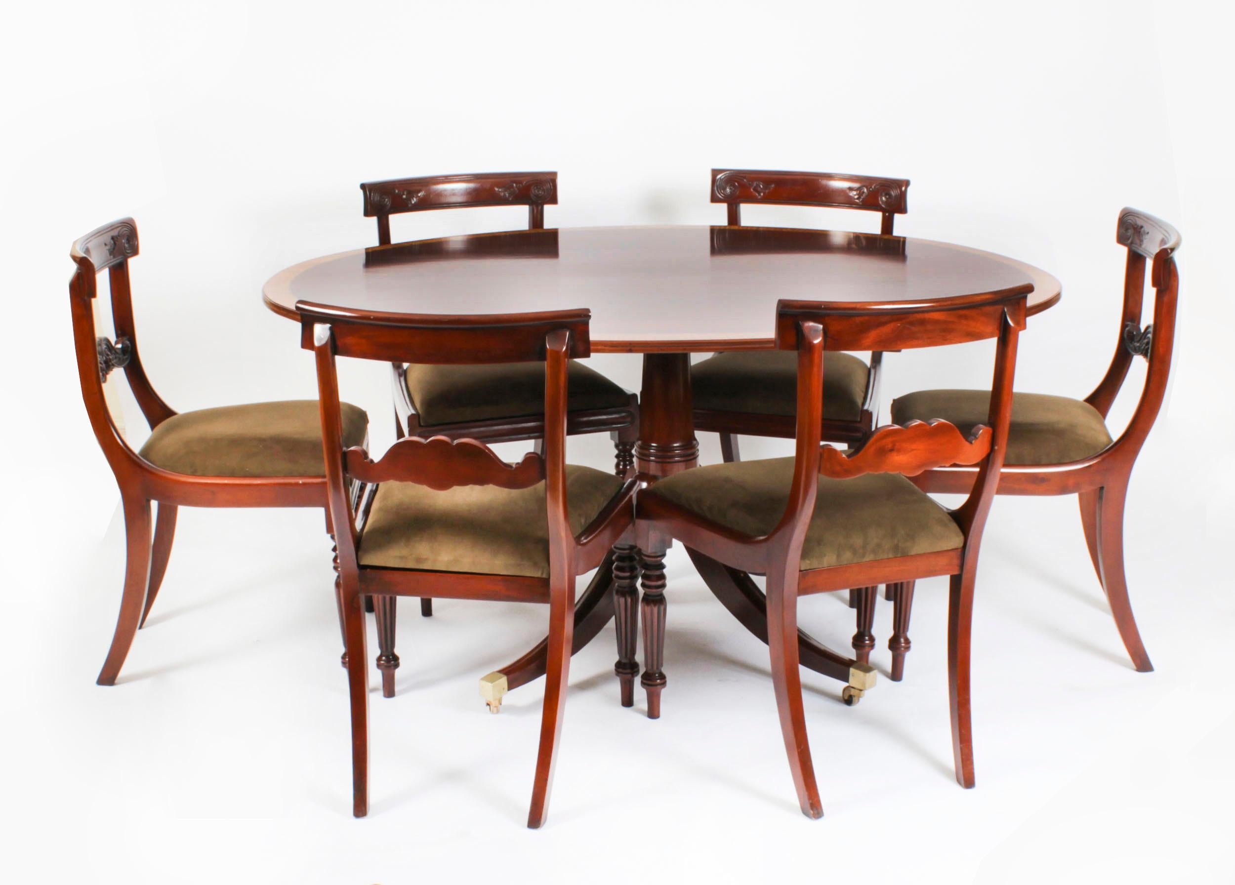This is a beautiful antique Regency Revival flame mahogany and Satinwood banded oval dining table circa 1900 in date.
 
The fabulous 5ft flame mahogany tilt top table can seat six people in comfort. The top is decoratively crossbanded in satinwood