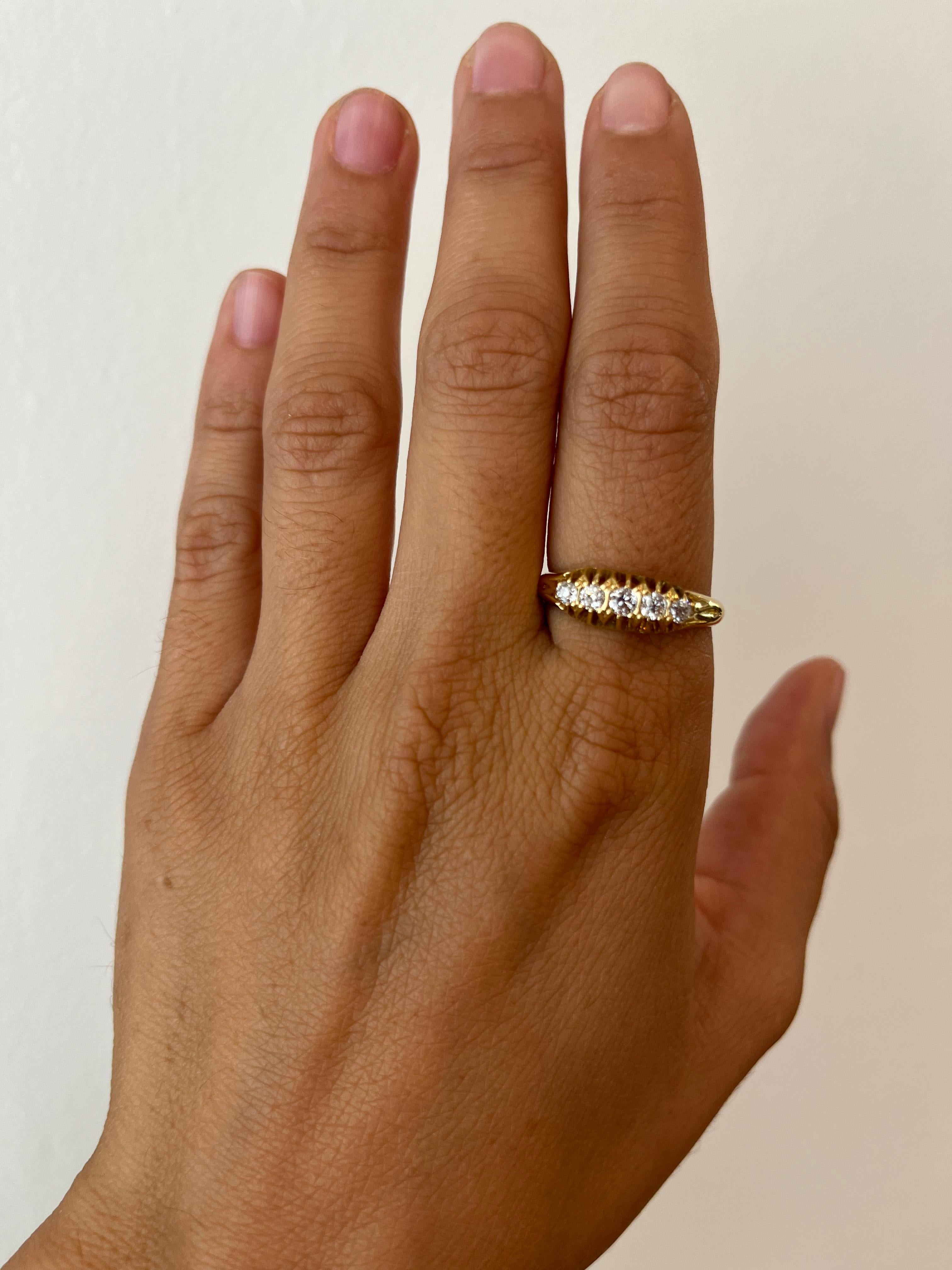 Antique Old English 18K yellow gold wedding band featuring 5 old mine cut diamonds that total 0.38ct. Set in a classic prong setting characteristic of the time, circa 1915. From our antique fine jewelry collection in Santa Monica, California.

- 5