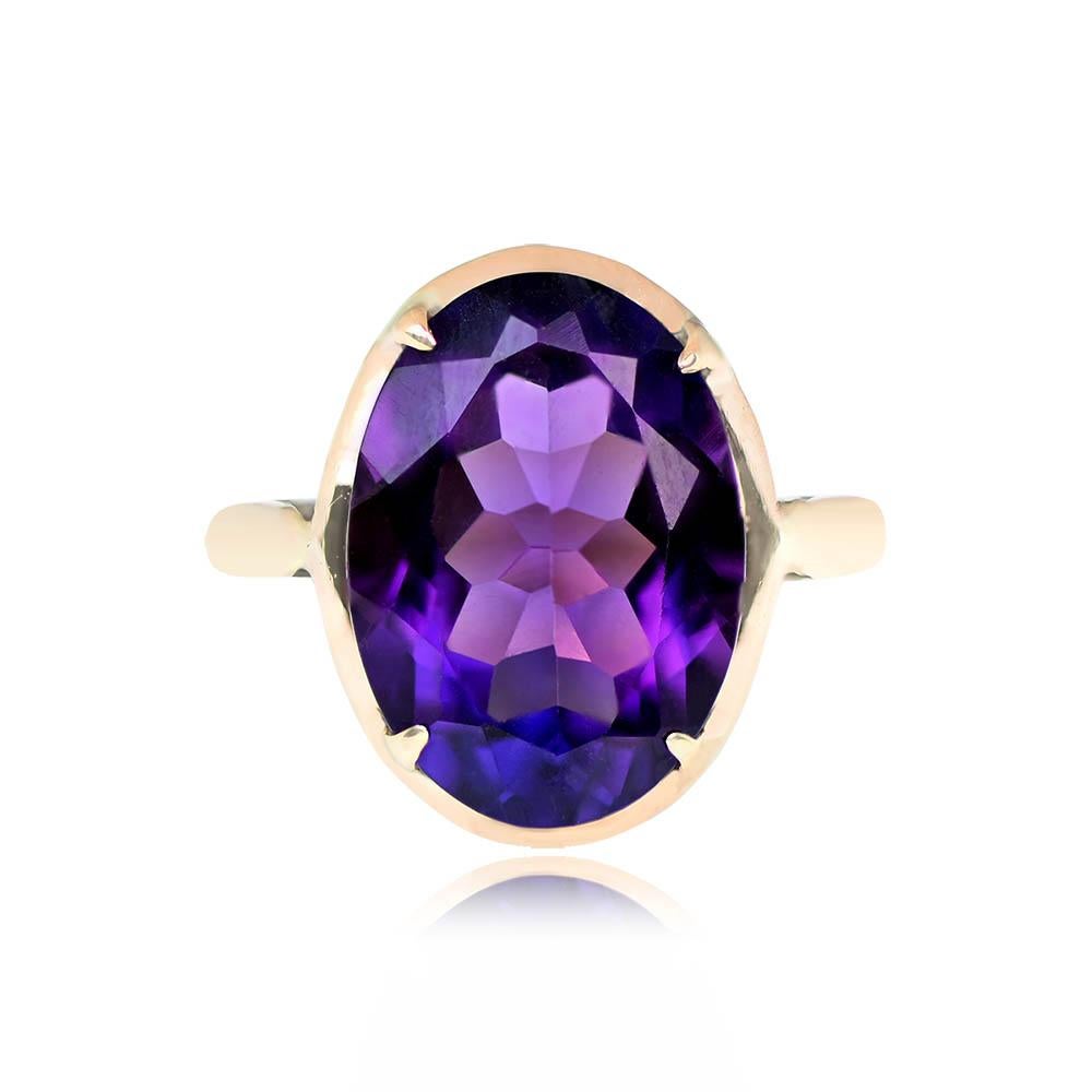 This antique ring boasts a captivating 5.03-carat oval cut deep-purple amethyst held securely in prongs. Accentuated by an intricate openwork gallery, the amethyst is elegantly mounted in yellow gold. Originating from the Victorian era, this ring