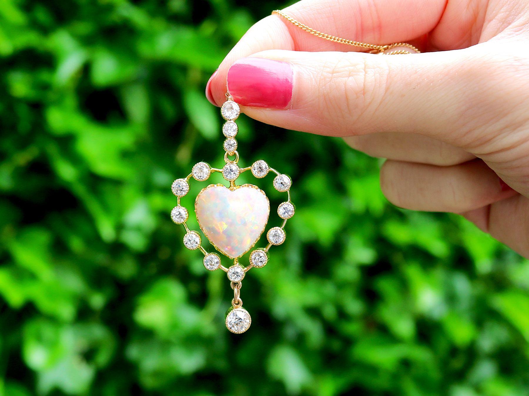 A magnificent, stunning, fine and impressive antique 5.48 carat opal and 2.91 carat diamond, 15 karat yellow gold heart pendant; part of our diverse antique jewellery and estate jewelry collections.

This magnificent, fine and impressive antique