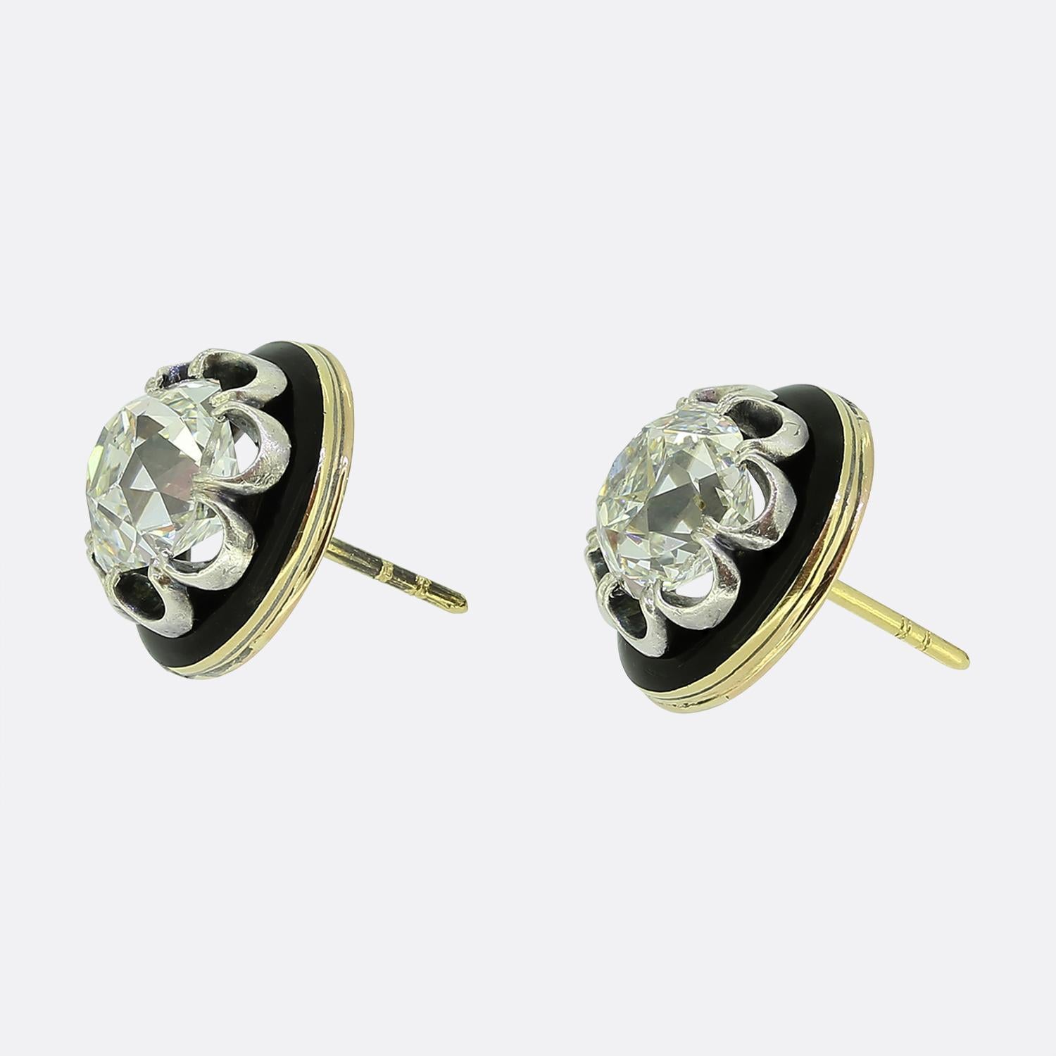 Here we have a truly stunning pair of diamond stud earrings. These two exquisite antique pieces each feature a captivating 2.90ct peruzzi cut diamond, claw set proud in an open undulating silver frame. The diamonds are then encircled by a delicate