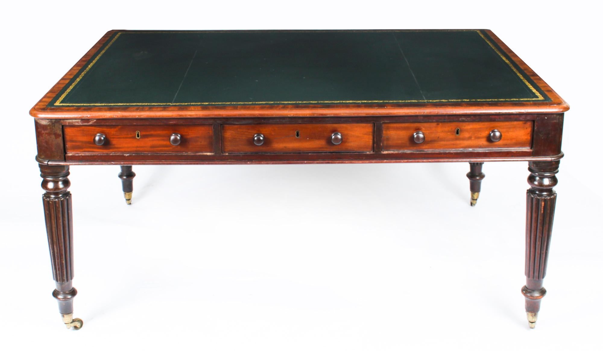 This is a superb antique William IV partners writing table in the manner of Gillows, crafted from beautiful mahogany and dating from Circa 1830.
 
The rectangular top features a moulded edge with an inset gold tooled leather writing surface over six