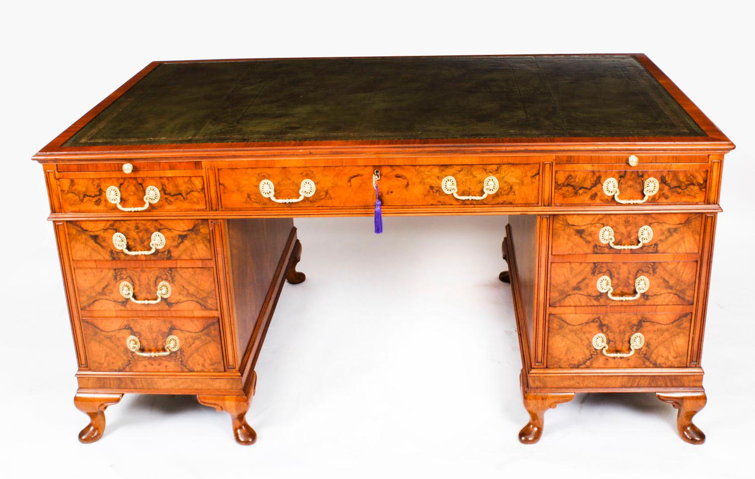 A superb English antique burr walnut partners pedestal desk, dating from Circa 1920.
 
The rectangular top is inset with a stunning gold tooled green leather writing surface.
 
One side of the desk is fitted with three frieze drawers and six