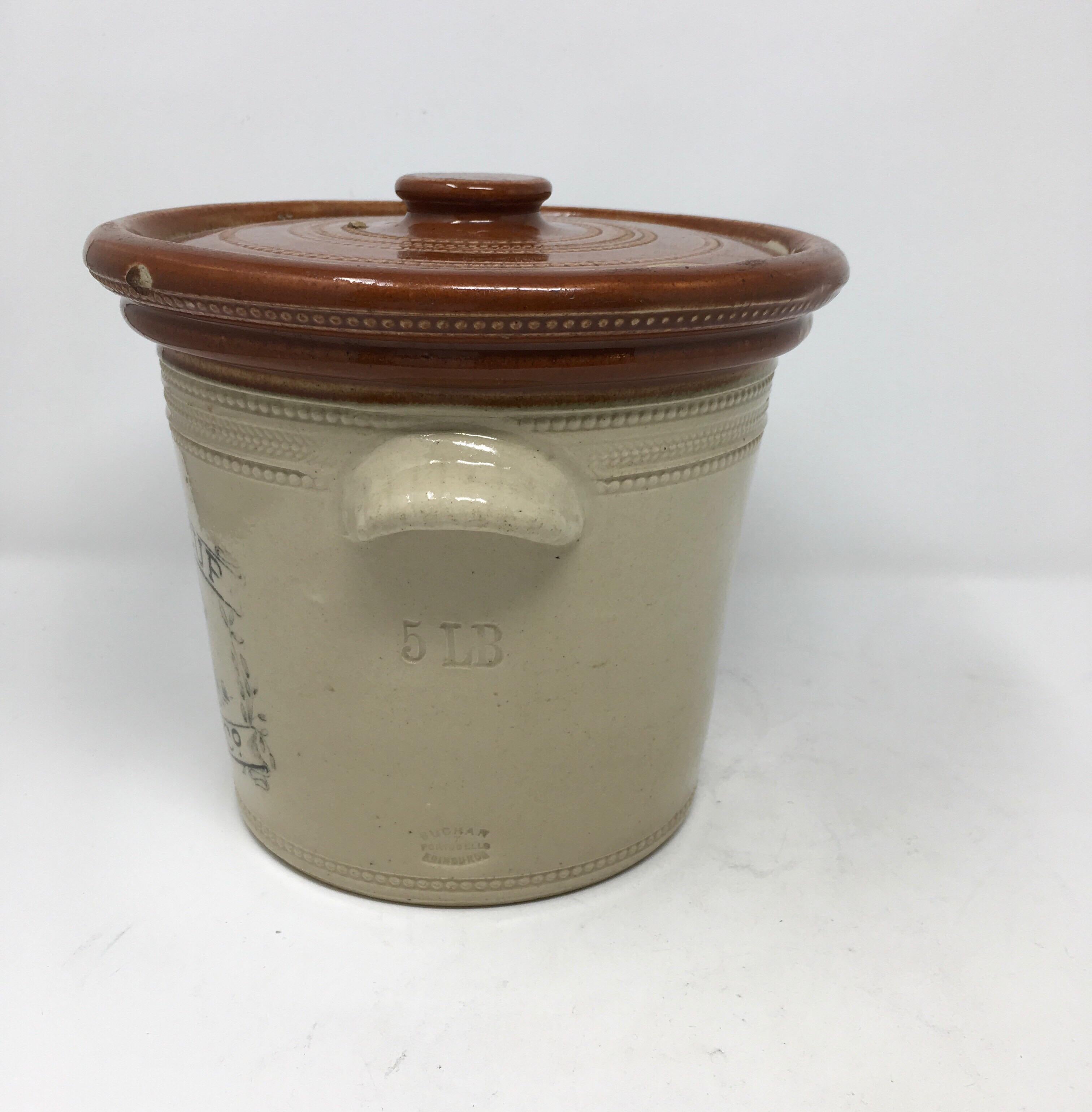 Imported from England, this is a large 5lb. circa 1920 Scottish printed advertising butter crock. The transfer printed butter crock with a pictorial of a dairy cow is from Buttercup Dairy Co. and is marked Buchan Portebello Pottery in Edinburg.