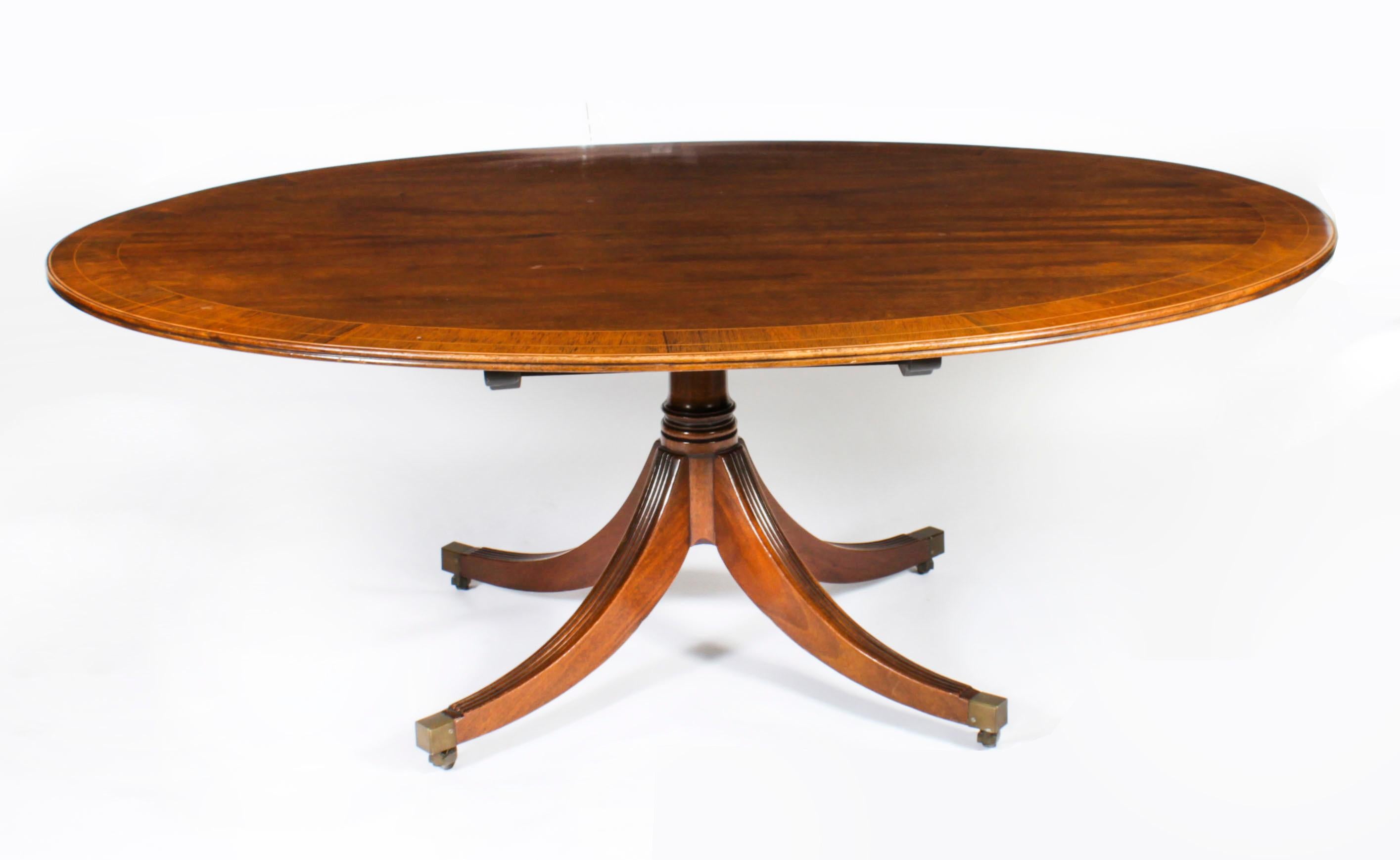 This is a beautiful antique Regency Revival flame mahogany and Gonçalo Alves banded tilt top oval dining table dating from Circa 1920. 
 
The fabulous 6ft 6inch flame mahogany tilt top table can seat eight people in comfort. The top is