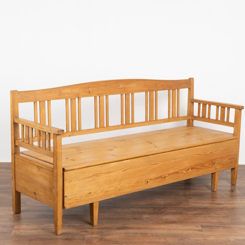 Antique Swedish country pine 6' long bench with open slat back and interior storage.
Bench seat is removeable; it originally served as a type of pull out spare bed.
Restored, strong, stable and ready for use; waxed finish.
Any scratches, cracks,
