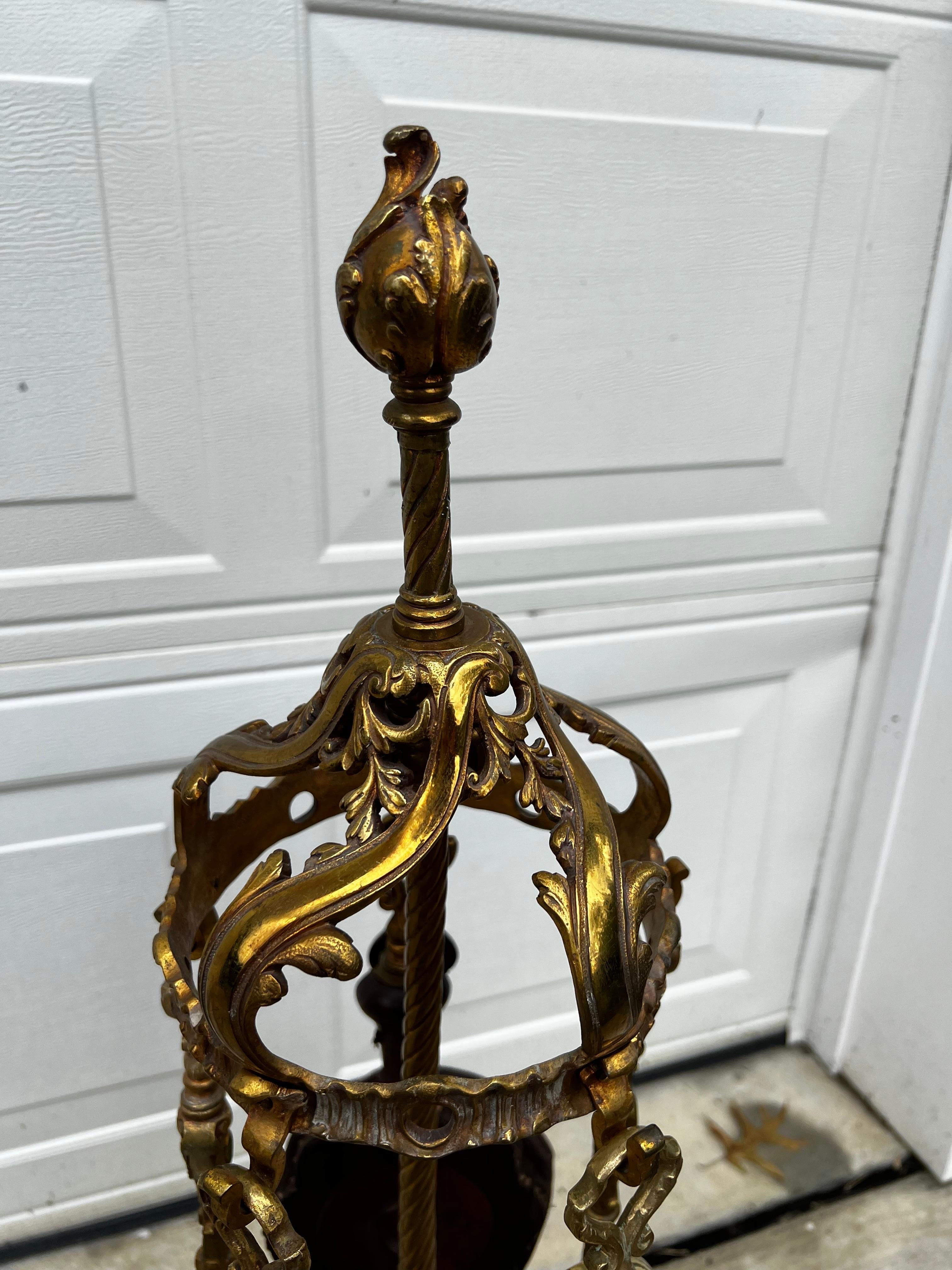 A magnificent  set of fireplace tools with stand. This extraordinarily crafted  stand with acanthus leaves design and 5 hook arms will stand out in your fireplace decor. 
All tools have intricate handle design and show the level of craftsmanship of