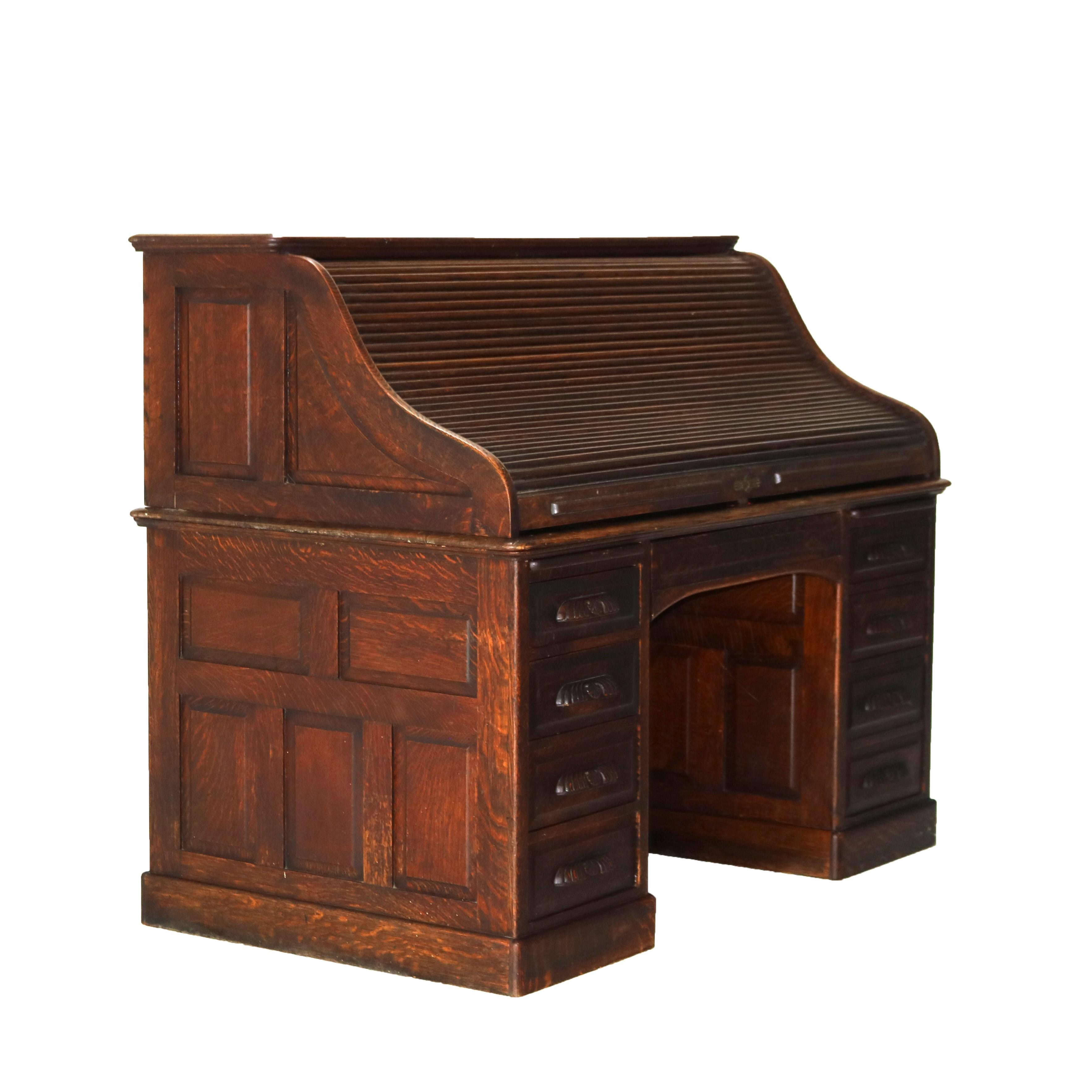 ***Reduced Delivery Rates - See Below or Click “Ask The Seller” to Request a Quote***

Antique 60” Oak S-Roll Top Executive Desk with 22 Interior Drawers, Foliate Carved Pulls, Stylized Sunburst Cast Brass Escutcheon and Raised Panels
