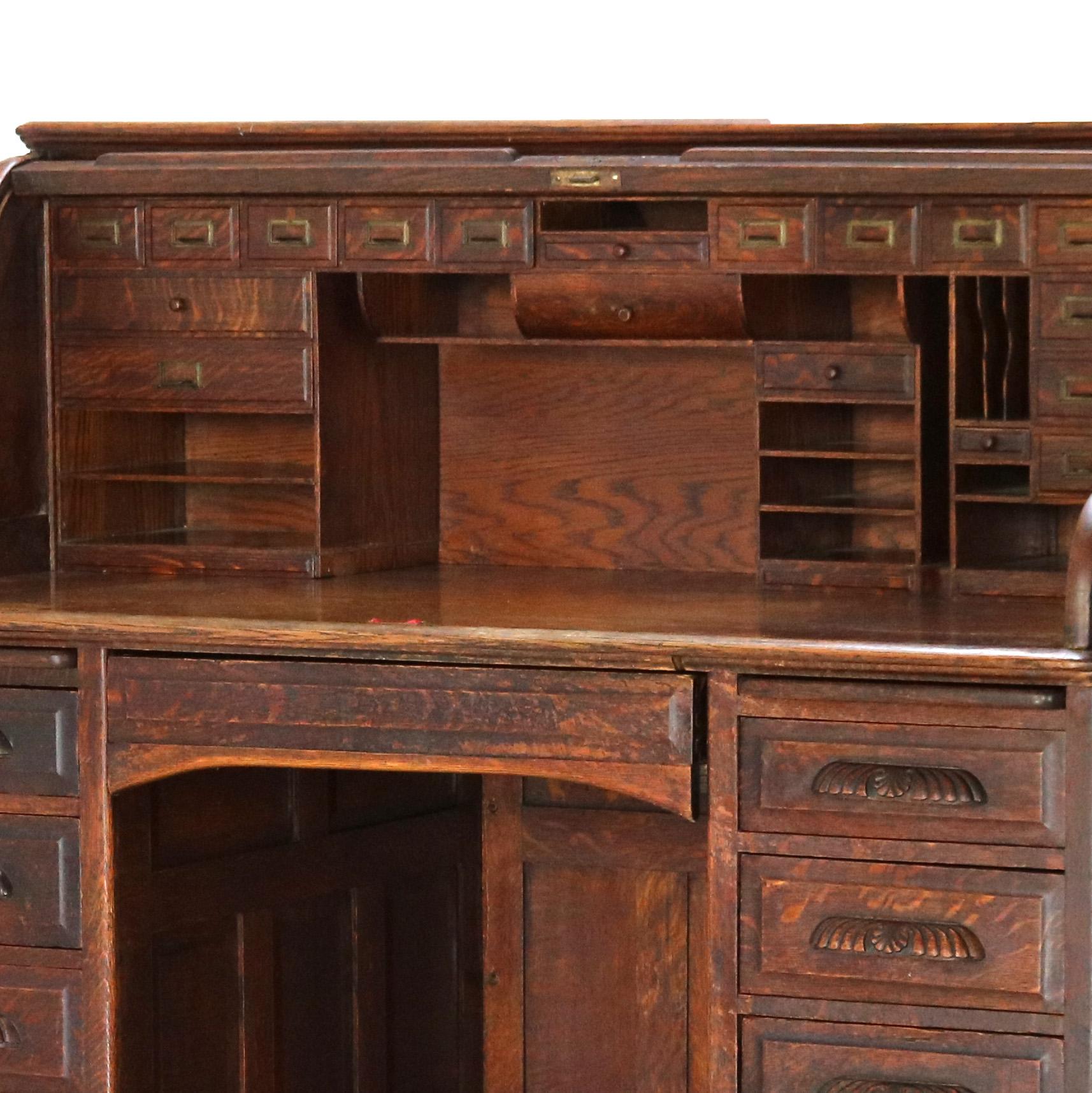 20th Century Antique 60” Oak S-Roll Top & Raised Panel Desk with 22 Interior Drawers, c1920