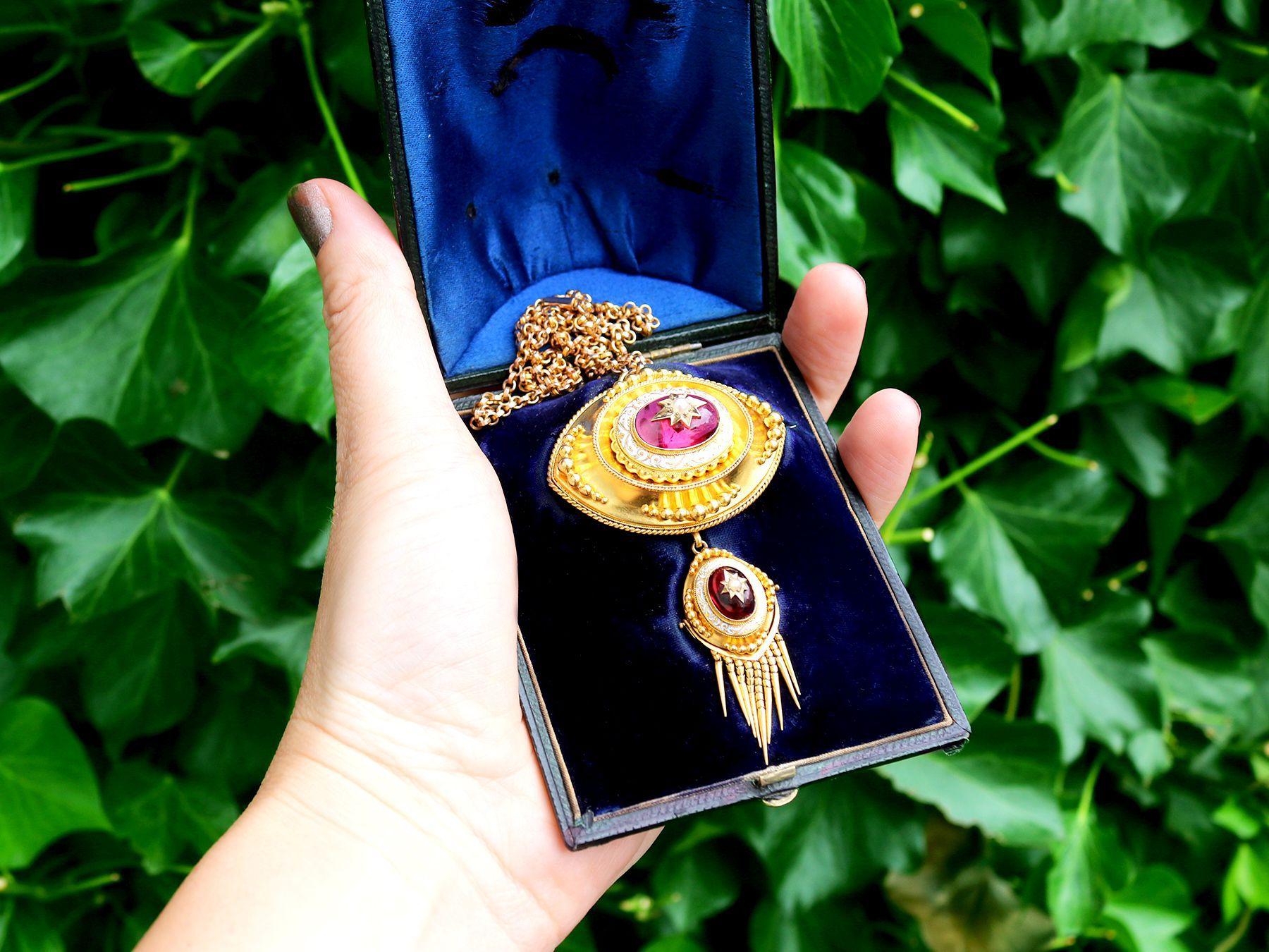 A stunning, fine and impressive antique 6.20 carat garnet, pearl and hot white enamel, 18 karat yellow gold pendant / brooch with a 9k yellow gold chain; part of our diverse antique jewelry and estate jewelry collections

This stunning, fine and