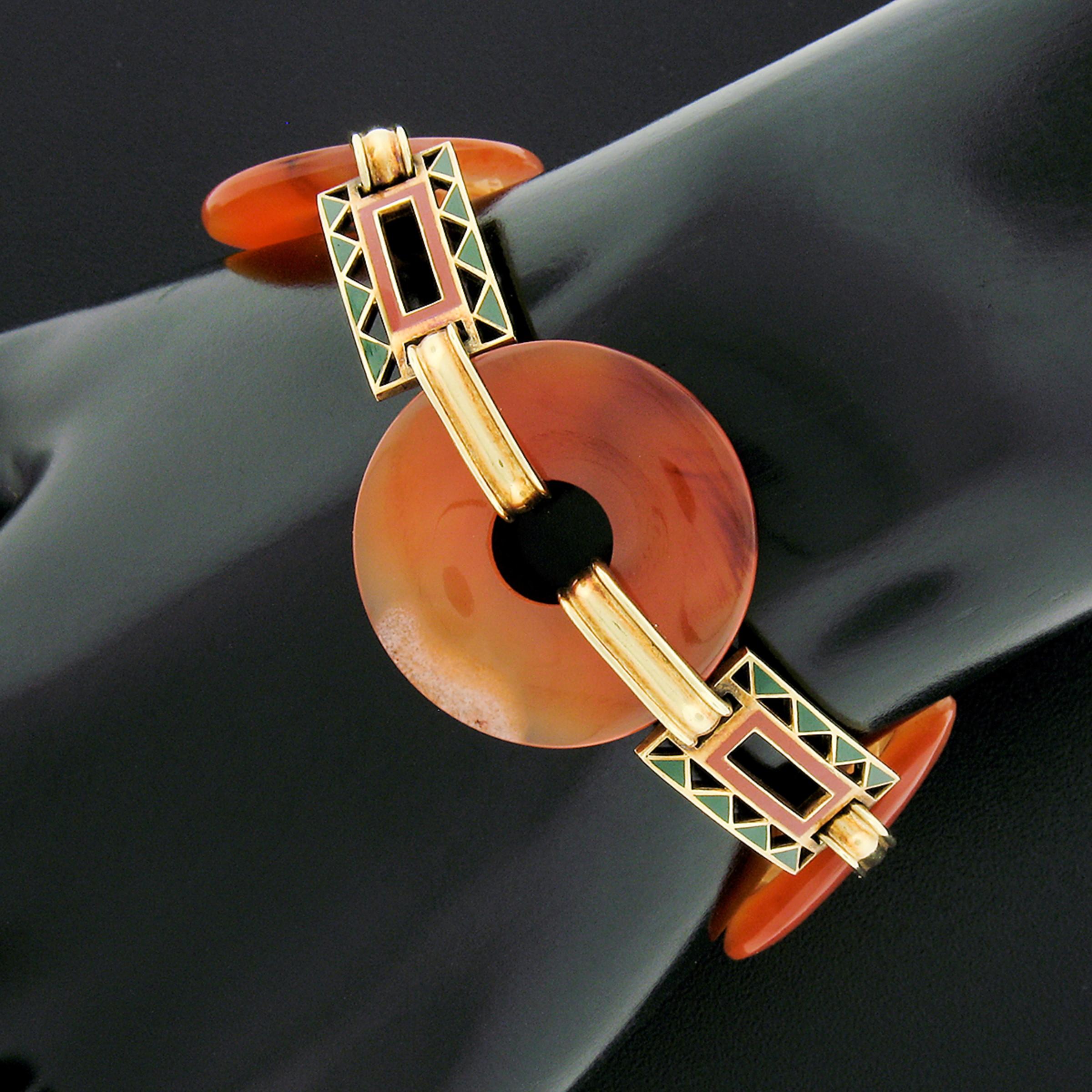 This truly breathtaking antique bracelet was hand crafted from solid 14k yellow gold and features three, absolutely gorgeous agate stones that are connected throughout by grooved links and three uniquely designed rectangular links that are decorated