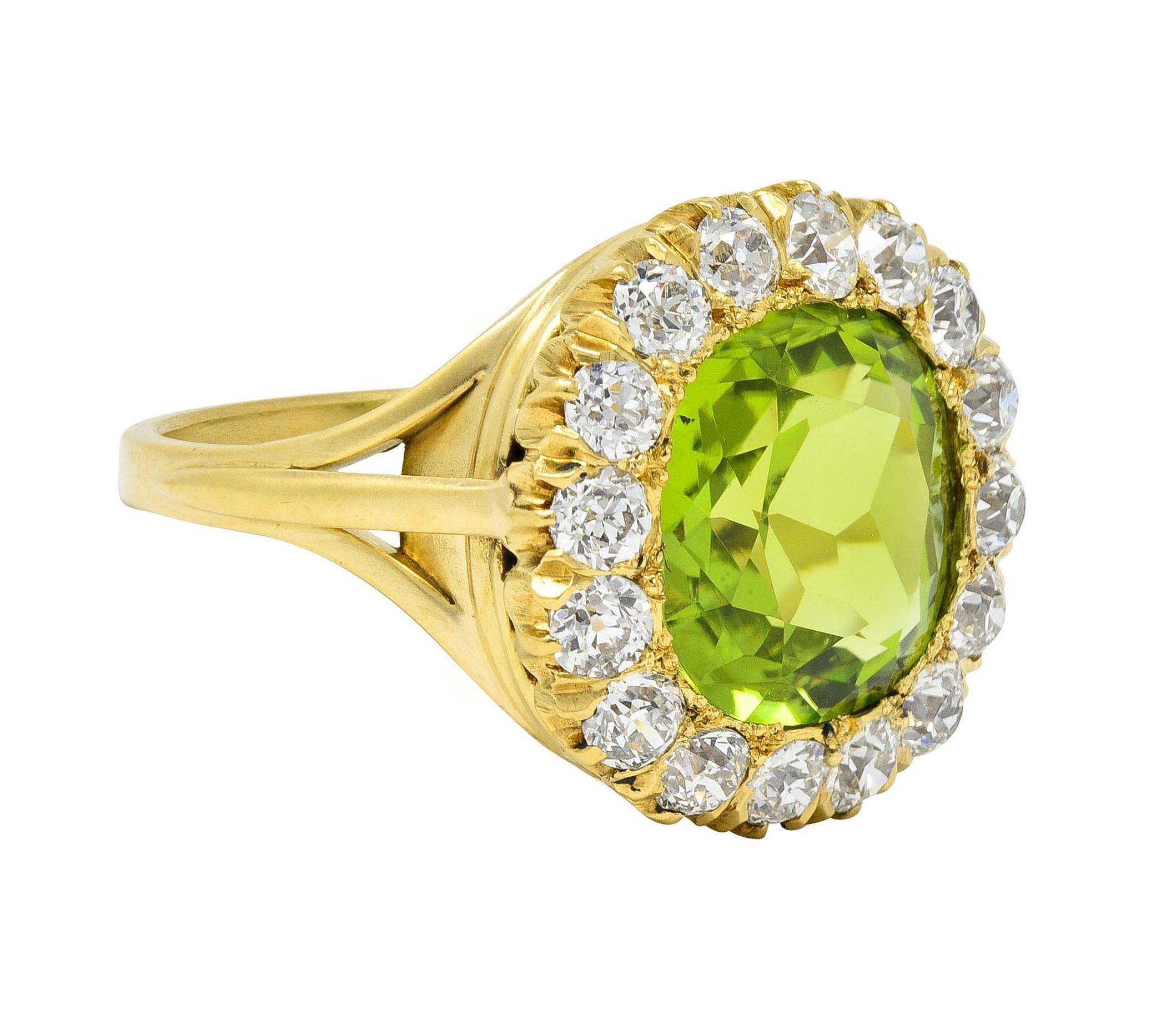 Centering a cushion-shaped mixed cut peridot weighing approximately 5.18 carats total 
Transparent vibrant yellowish green in color and bead set with halo surround
Comprised of prong set old European cut diamonds 
Weighing approximately 1.60 carats