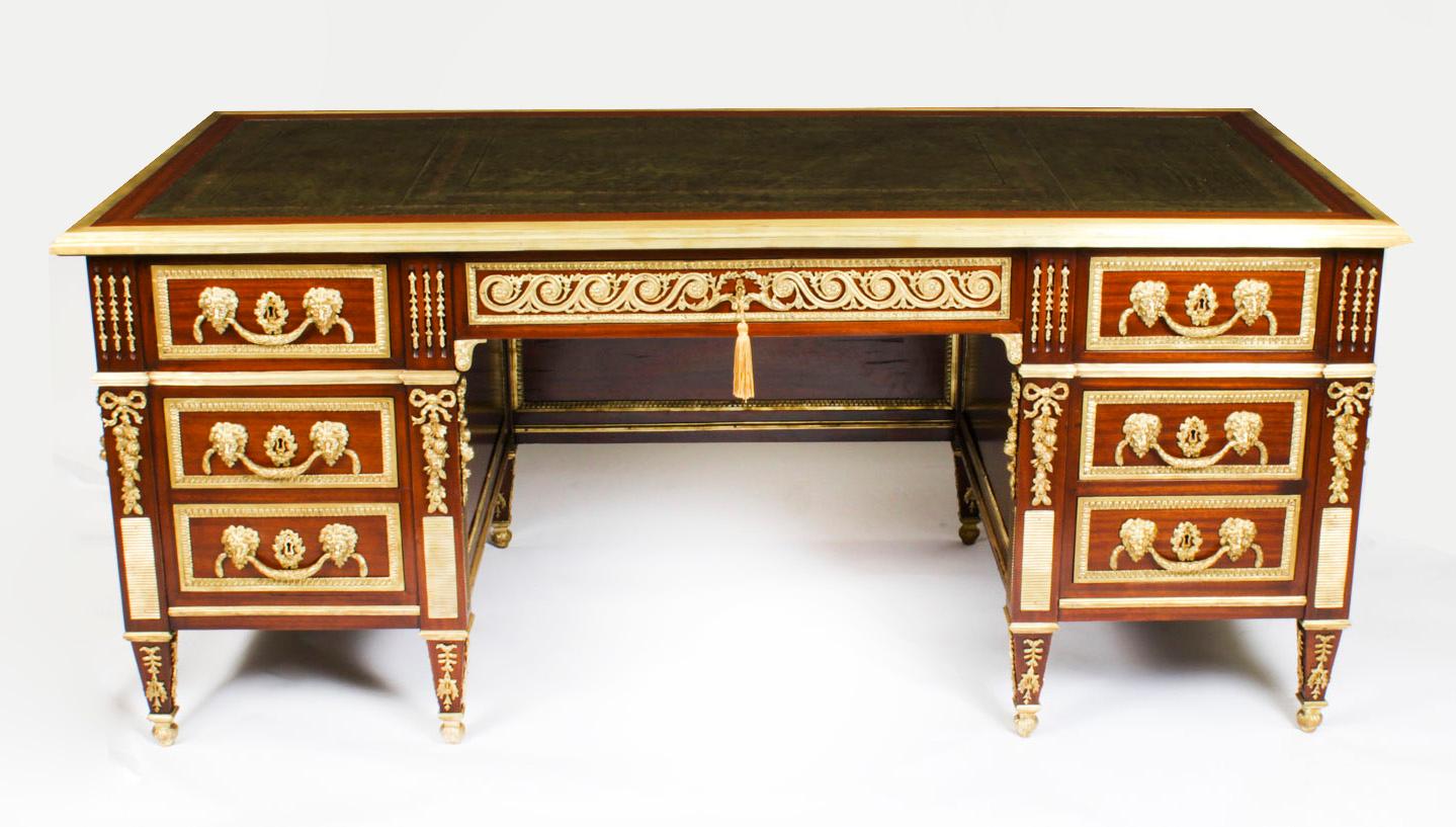 This is an exquisite antique French Empire Revival pedestal desk, Circa 1920 in date.

This desk has been beautifully crafted from flame mahogany. The top has a decorative ormolu boder and is inset with a beautiful gold tooled green leather writing