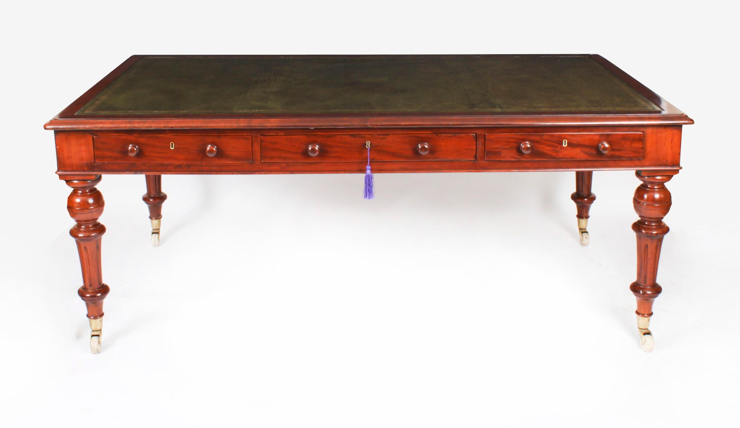 This gorgeous Victorian antique partners library table is crafted from beautiful flame mahogany and dates from Circa 1860.

It features a striking inset green leather writing surface that has beautiful hand tooled and gilded impressed decoration. It