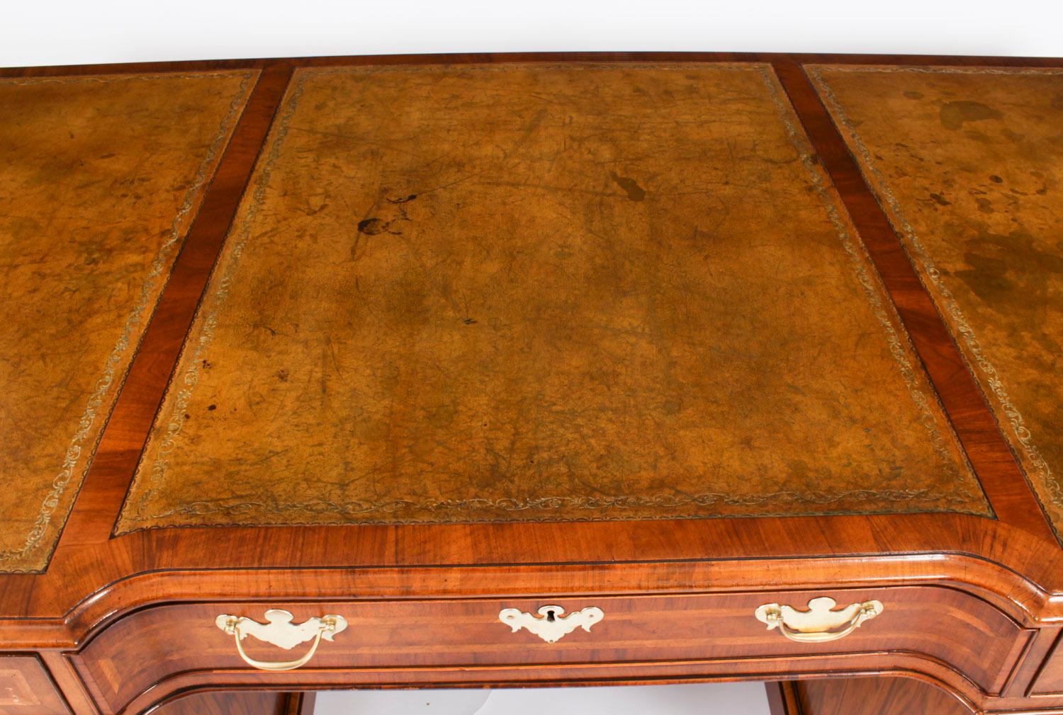 A large and impressive antique burr walnut and feather banded 6ft partners Pedestal desk, circa 1920s in date.
 
The shaped rectangular top with feather banding is lined with the original inset three panelled tan leather writing surface which