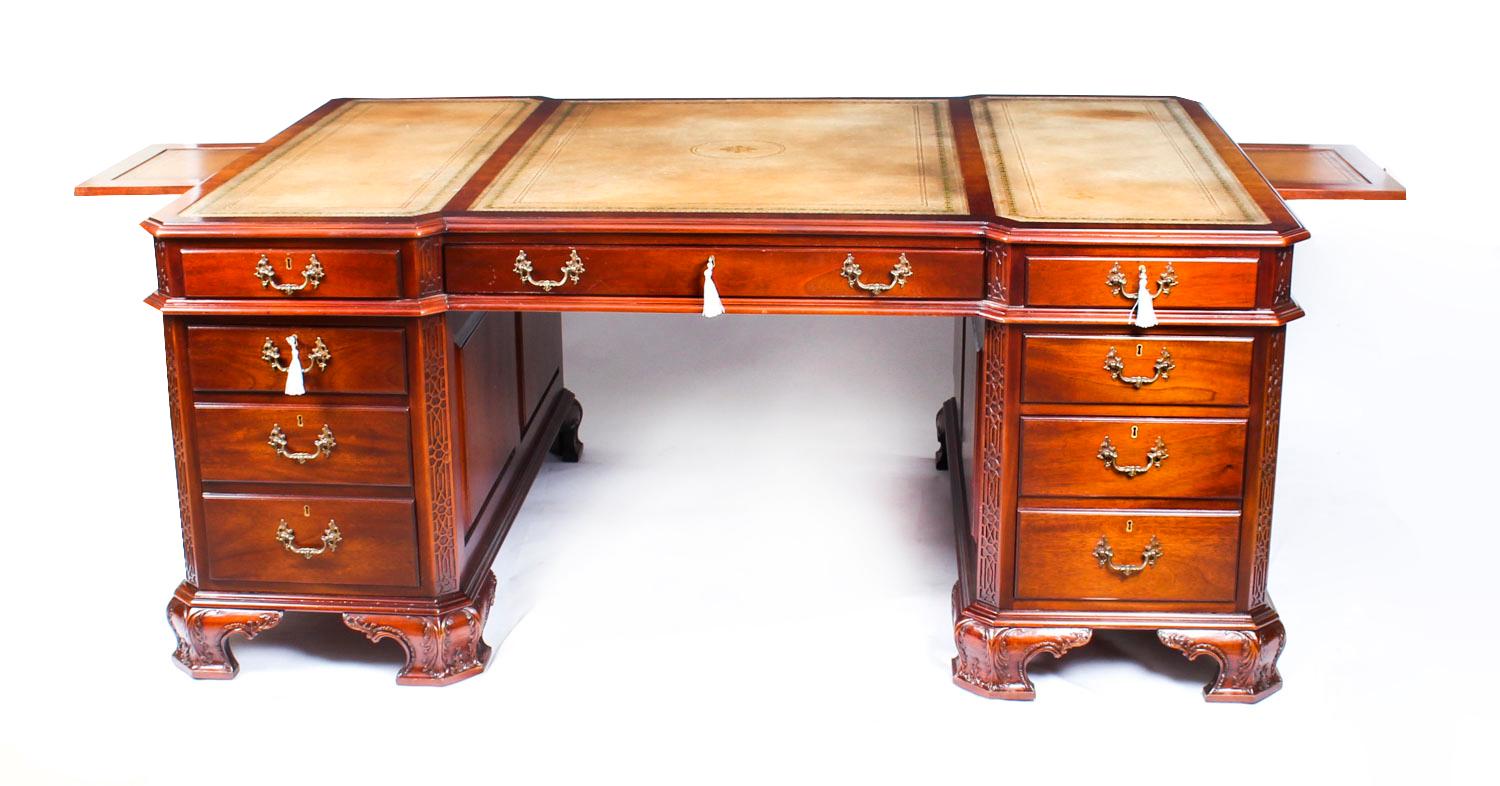 This is a beautiful antique mahogany Chippendale design pedestal partners desk, circa 1920 in date.

The shaped top features a moulded edge and is inset with the original light tan tooled leather writing surface. The desk is a partners desk and