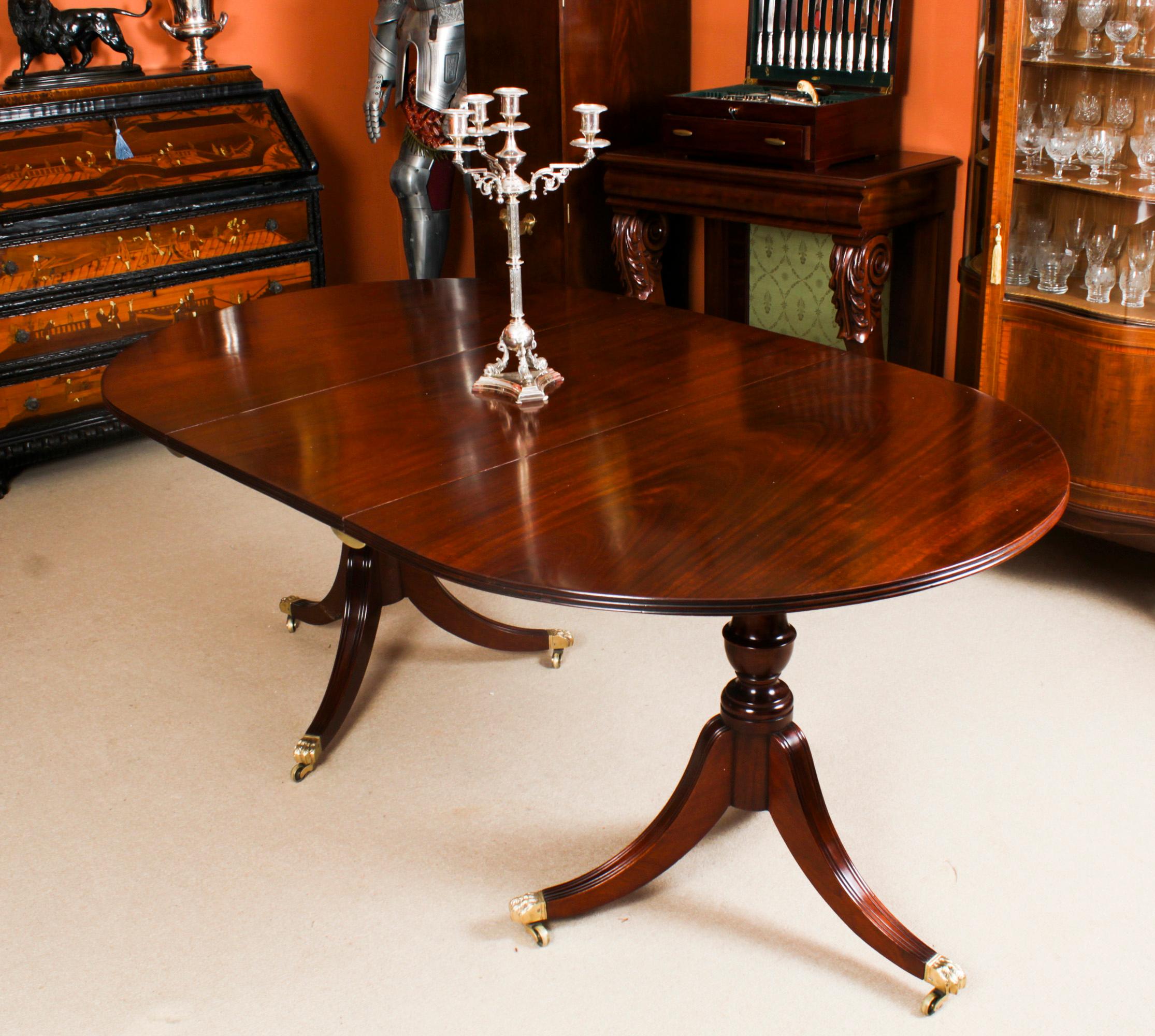 This is an elegant antique Regency dining table that can comfortably seat six people, Circa 1830 in date.
 
The table is of oval form with reeded edge. It is raised on twin urnular pillars with triple swept sabre leg bases which are fitted with