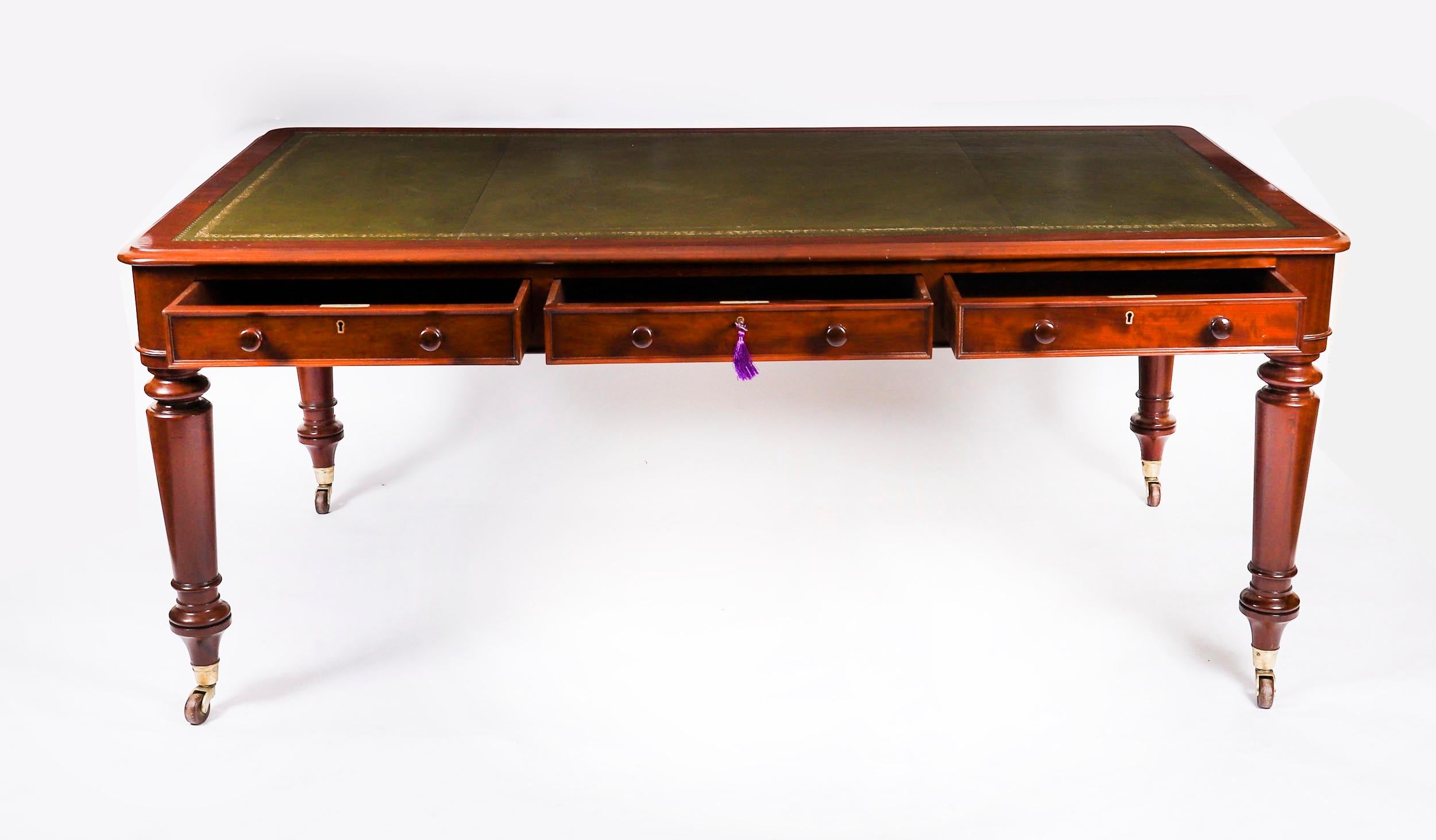 This gorgeous Victorian antique partners library table is crafted from beautiful flame mahogany and dates from Circa 1860.

It features a striking inset green leather writing surface that has beautiful hand tooled and gilded impressed decoration. It