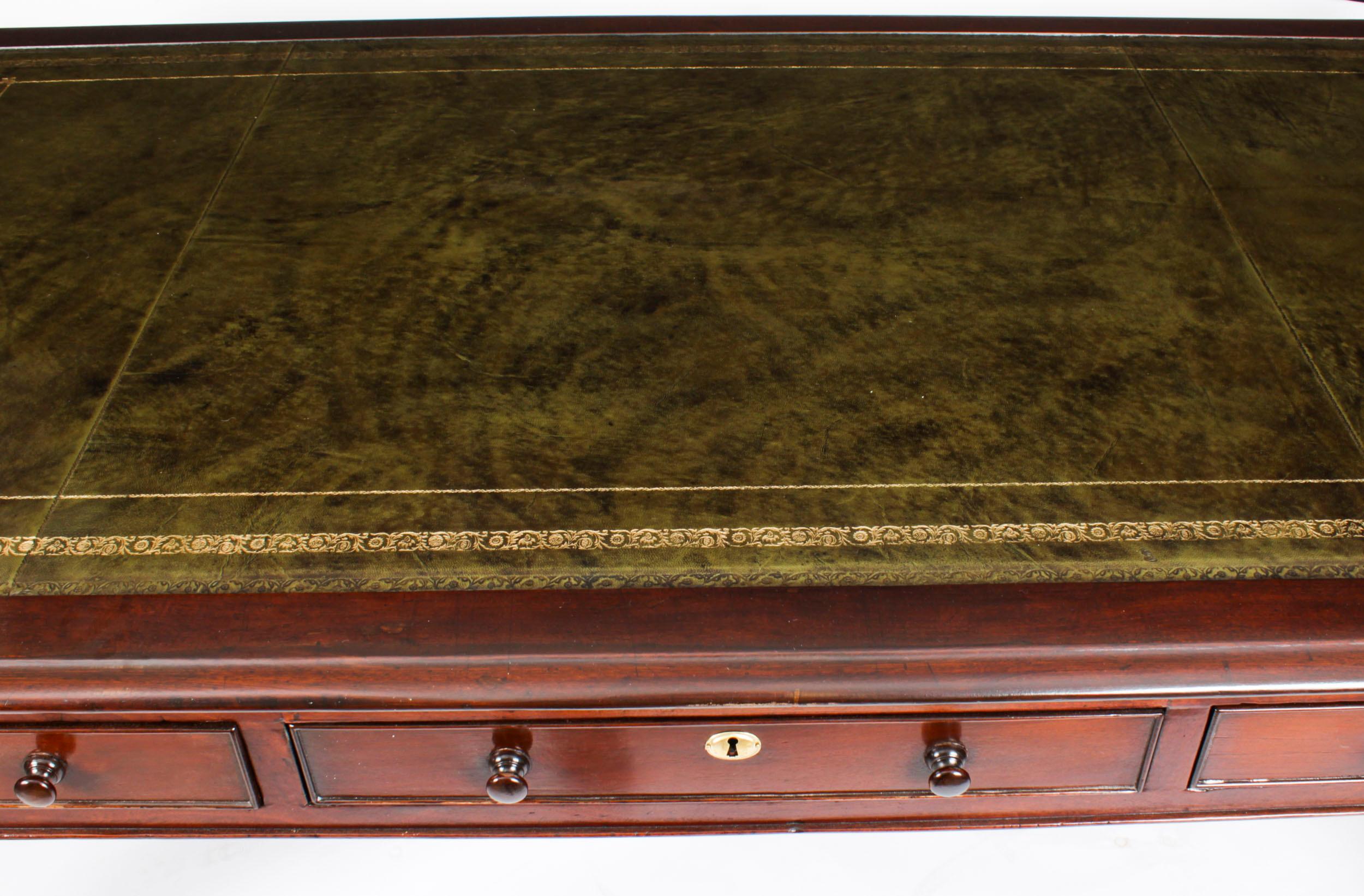 This monumental early William IV antique partners library / writing table is crafted from beautiful mahogany and dates from circa 1840.
 
The rectangular top features a moulded edge with a striking green leather top that has beautiful hand tooled