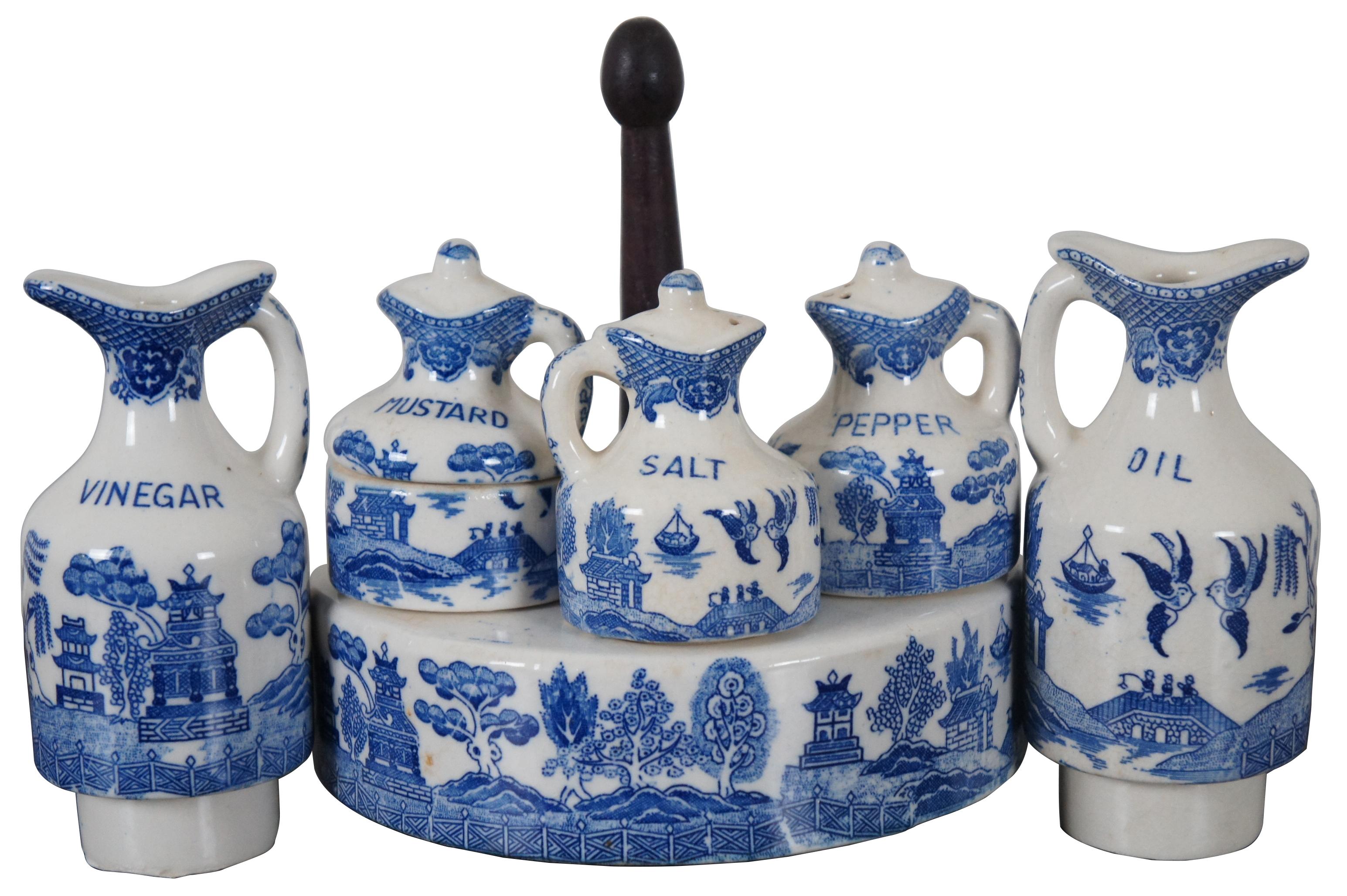 Antique blue willow pattern porcelain cruet or condiment set featuring a circular lazy Susan base on a wood dolly, labeled salt and pepper shakers, oil and vinegar bottles, and mustard pot.

Measures: Jugs - 2.25” x 5” / Shakers - 2” x 3.75”
