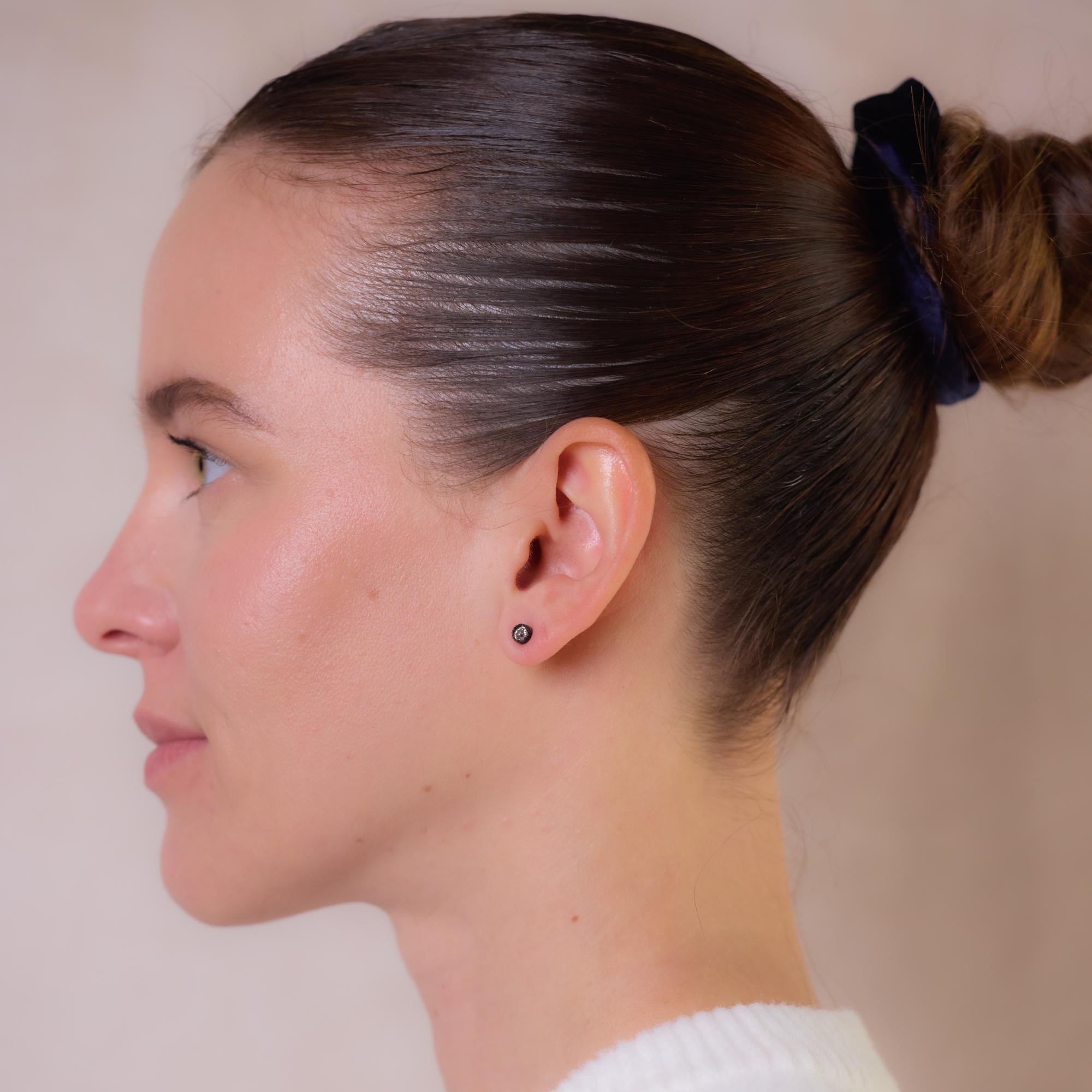 These antique 14k rose gold and silver stud earrings feature two old European cut diamonds totaling approximately 0.75 carats, G-H color, I clarity. Repurposed from an antique brooch, they retain their original settings, with only posts added for
