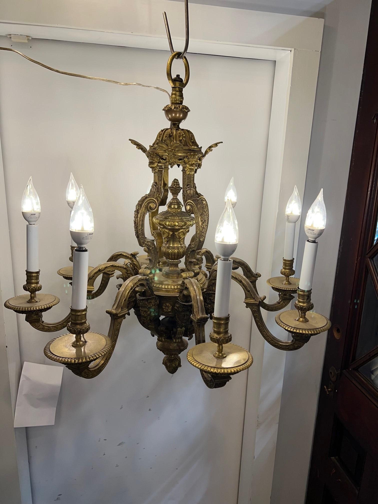 Late 19th Century antique bronze French chandelier with male and female busts under each arm. This is a very ornate bronze chandelier and a practical size that would look great over a table or center island. The male bust looks to be Bacchus the God