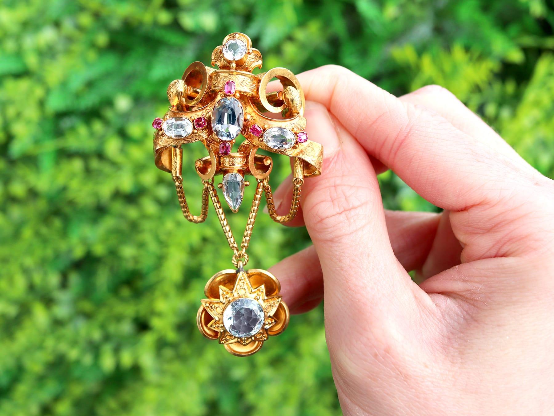 An exceptional, fine and impressive antique 8.65 carat aquamarine and 0.20 carat ruby, 21 karat yellow gold brooch; part of our diverse antique Victorian brooch collections.

This exceptional, fine and impressive antique, early Victorian brooch has